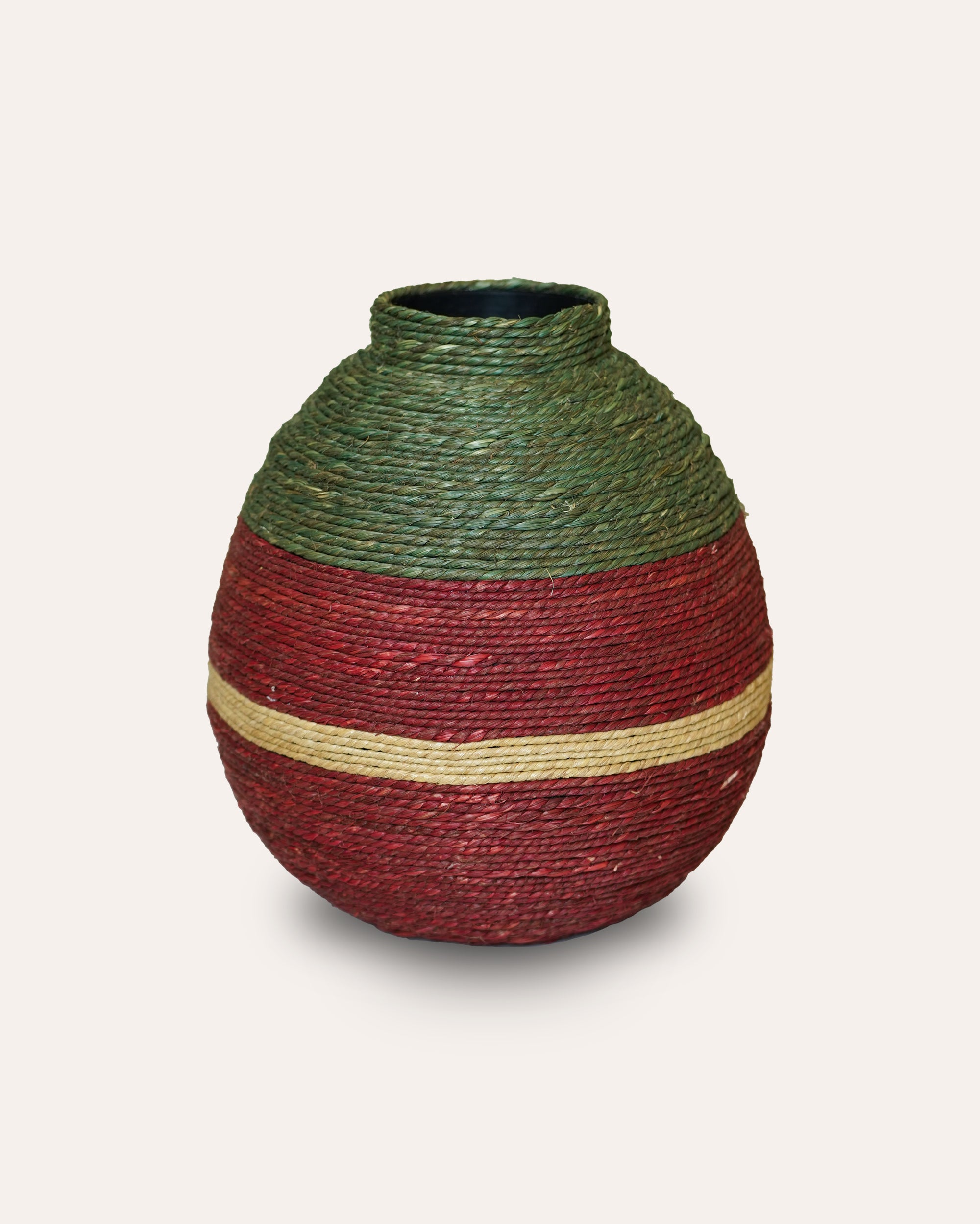 Decorative vase with green top and red body on a light white background
