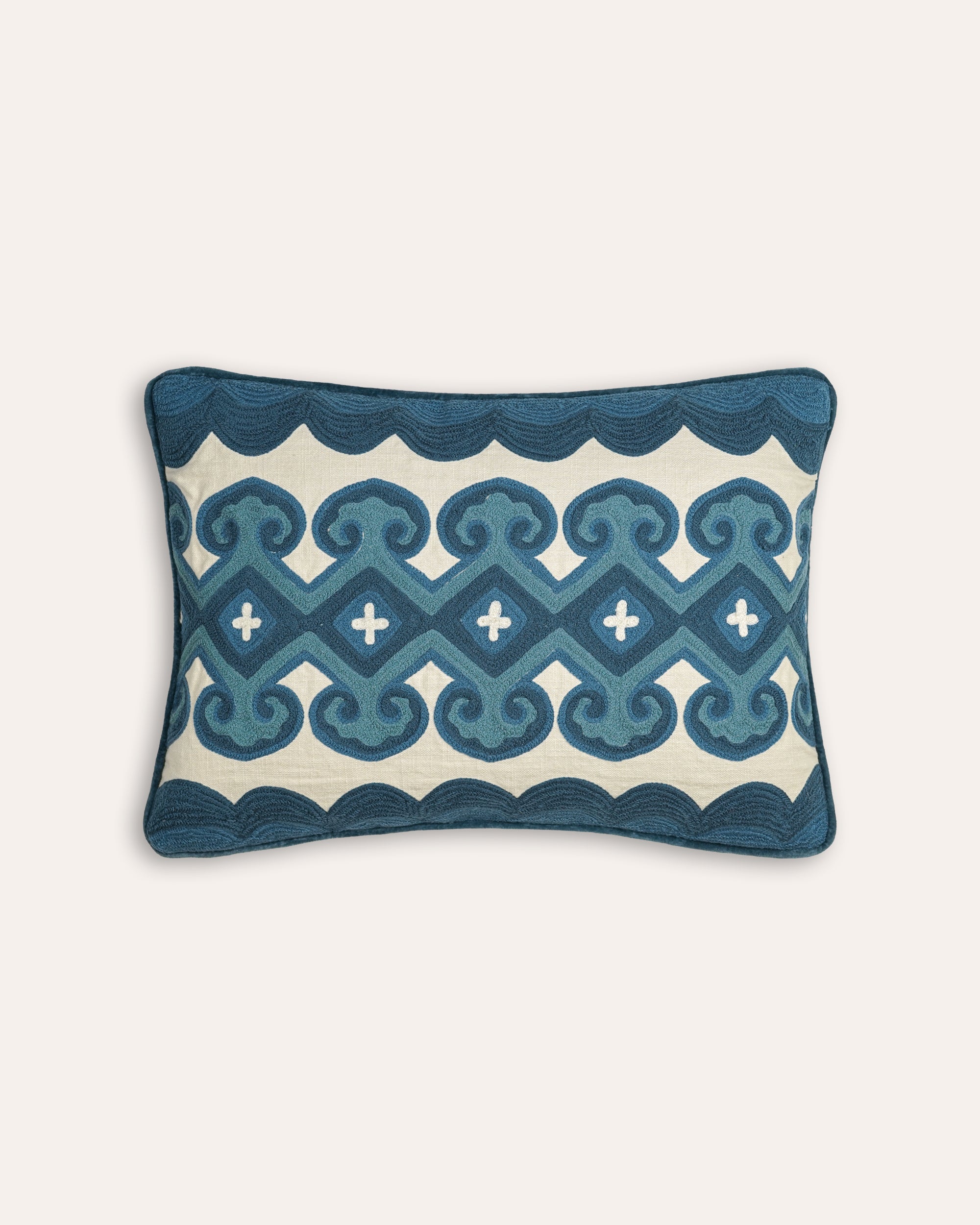 Decorative cushion with blue geometric pattern on a white background