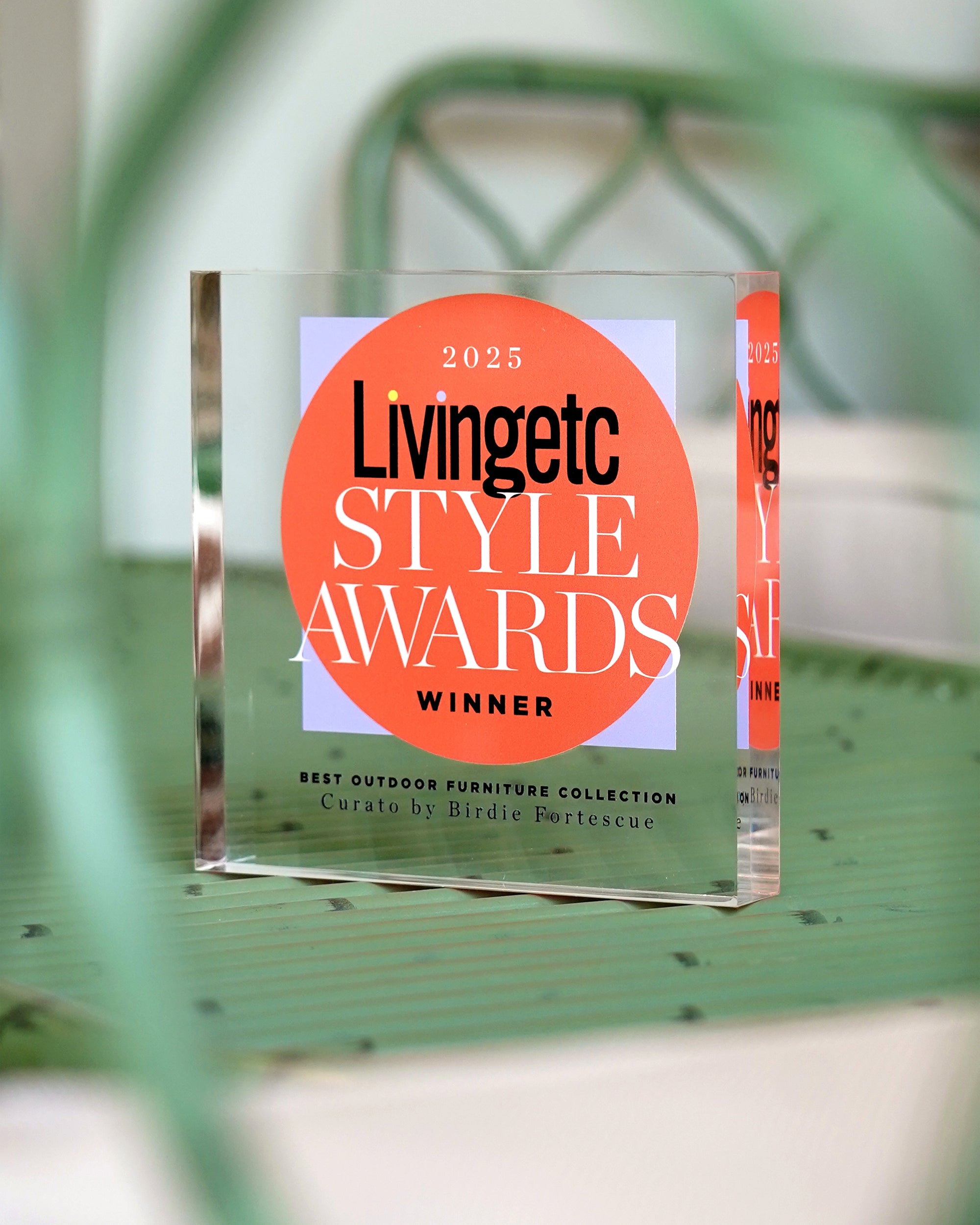 Livingetc Style Awards winner plaque on a green outdoor chair