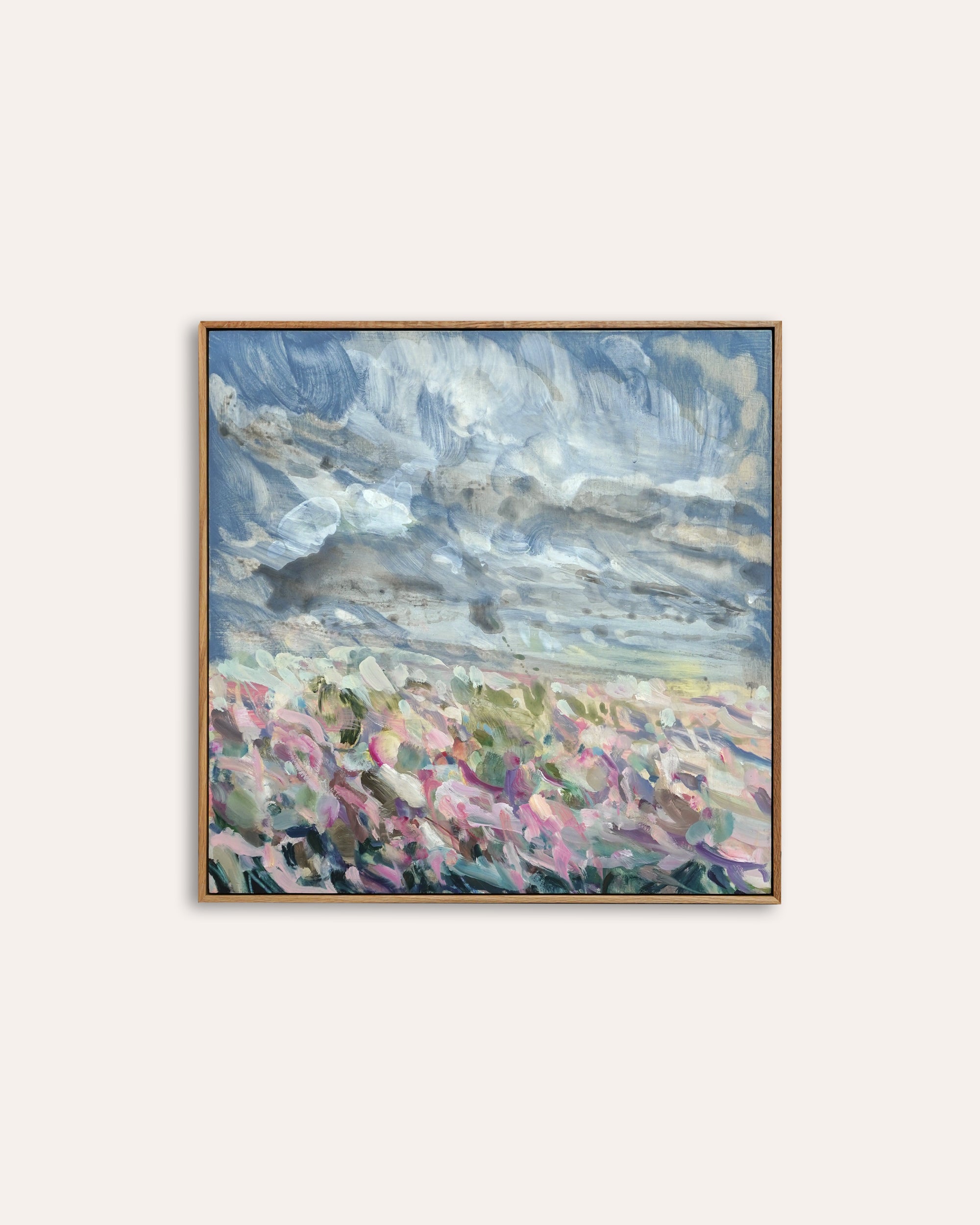 Framed abstract painting with colorful landscape on a white background