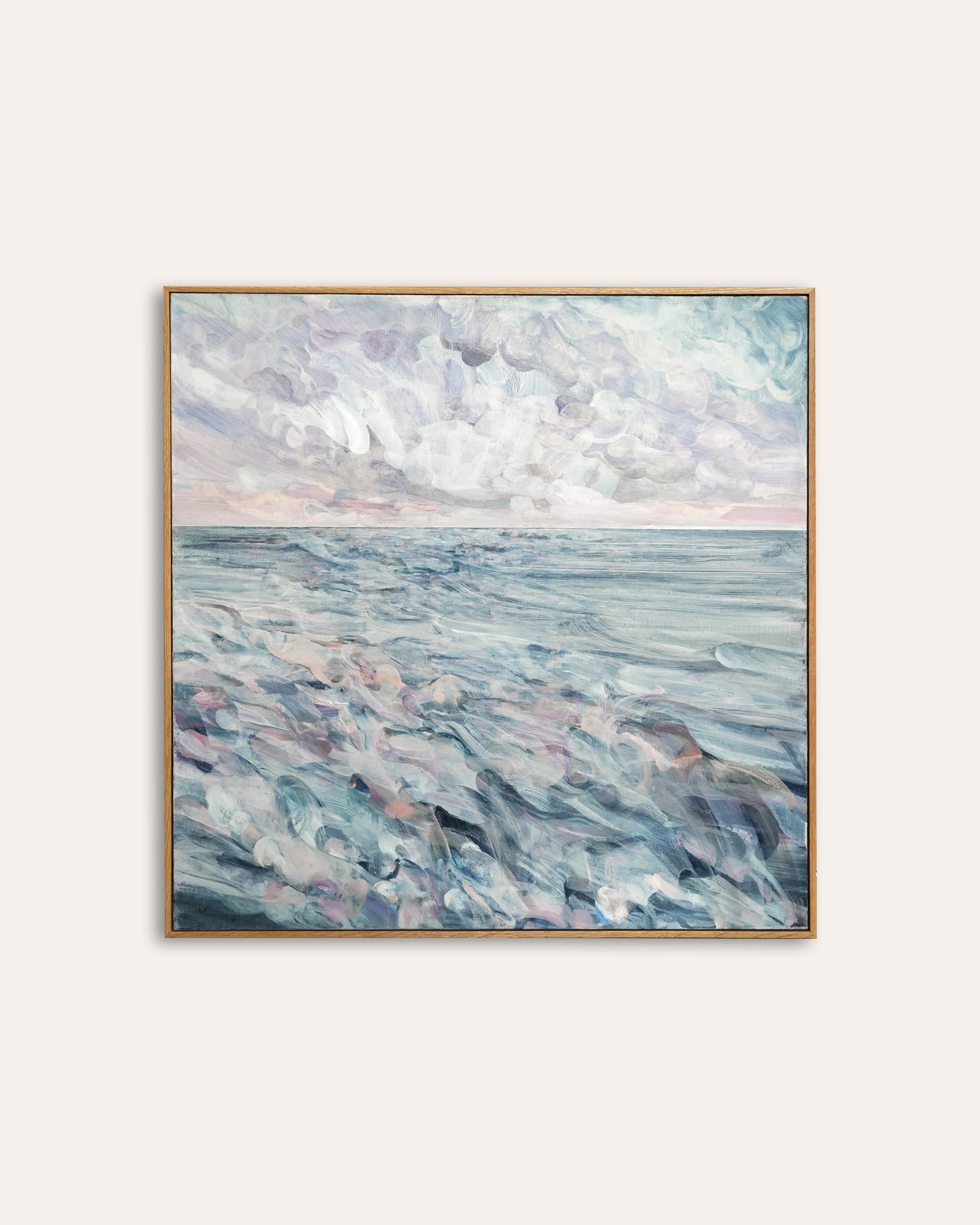 Framed artwork of a seascape with wavy water and cloudy sky.