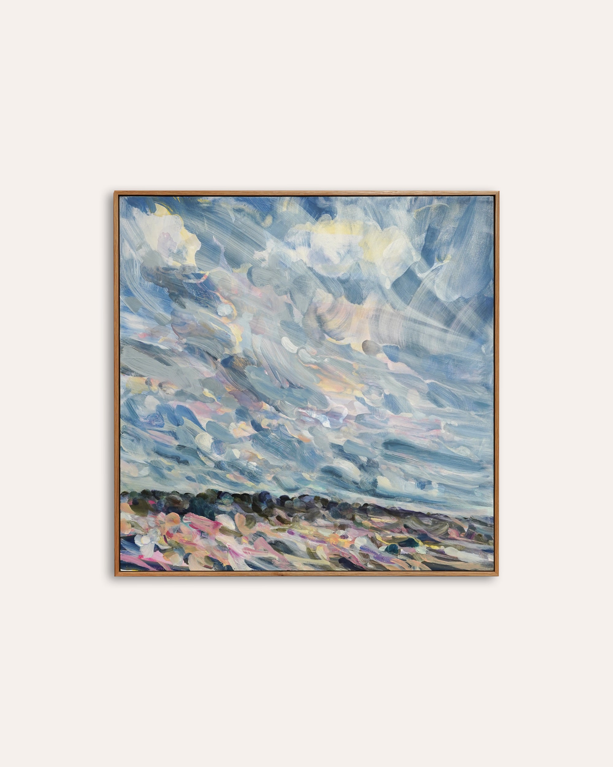 Framed abstract painting with blue and purple hues on a white wall