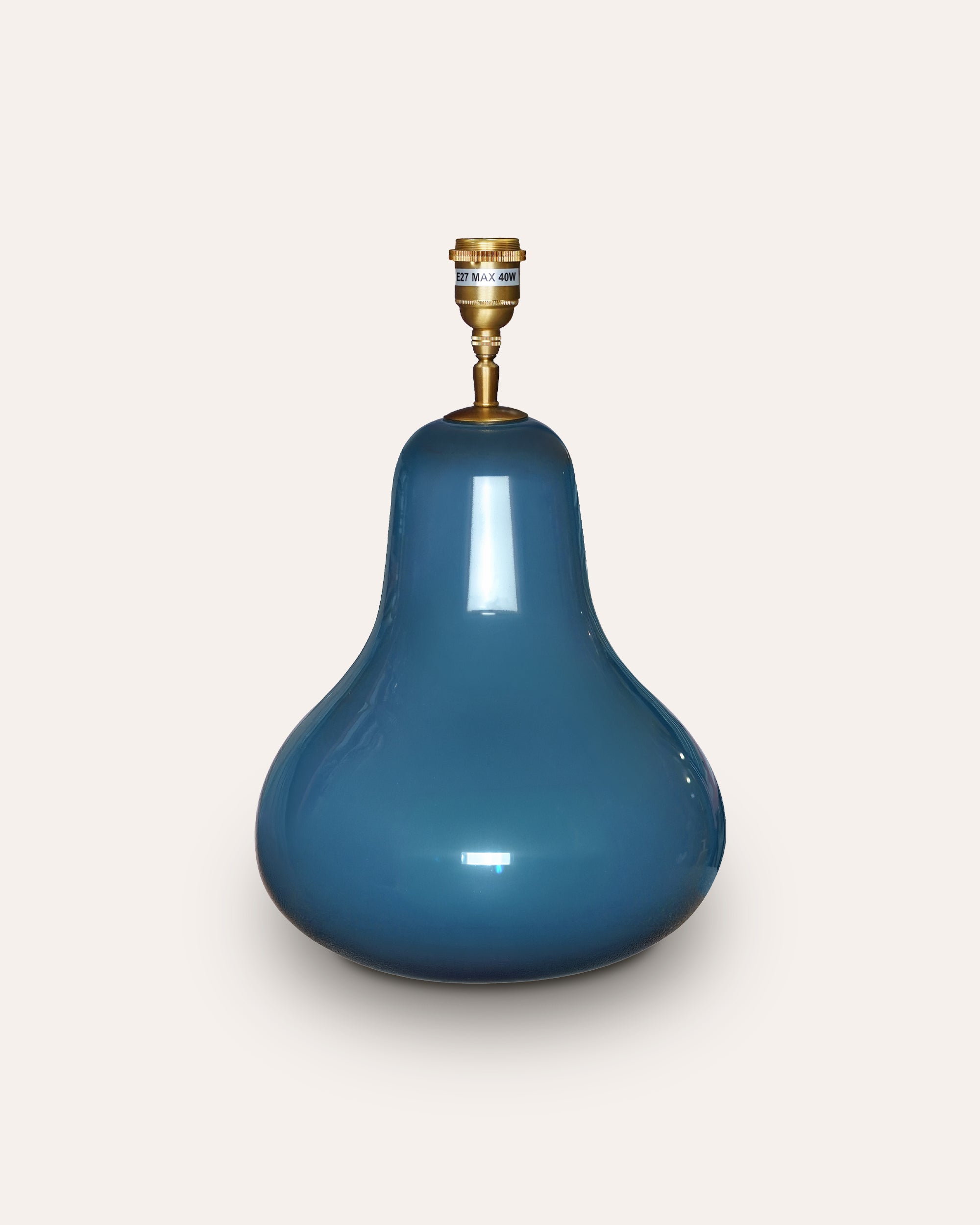 Blue ceramic pear shaped table lamp on a light grey background