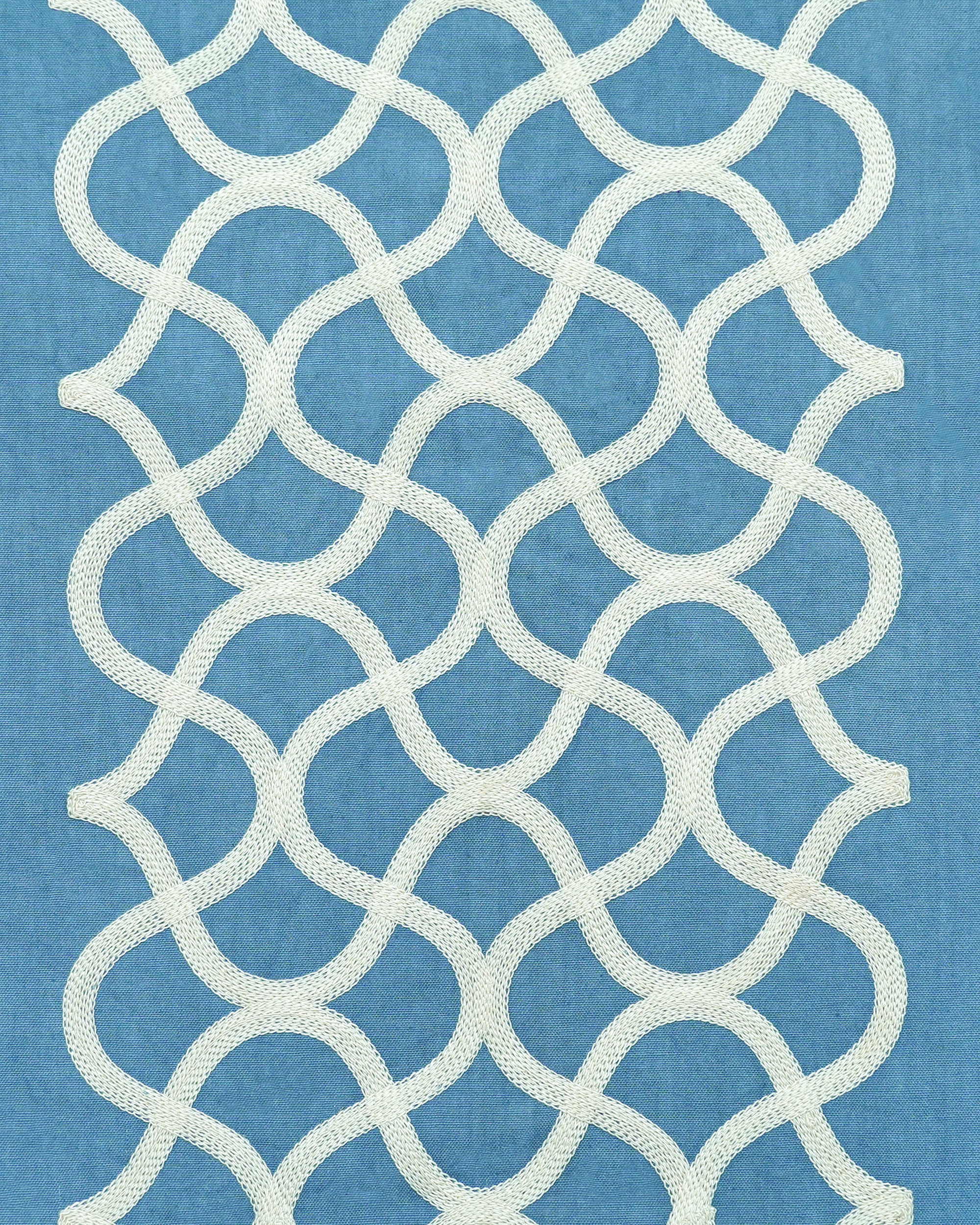 White geometric lattice pattern on a blue tablecloth