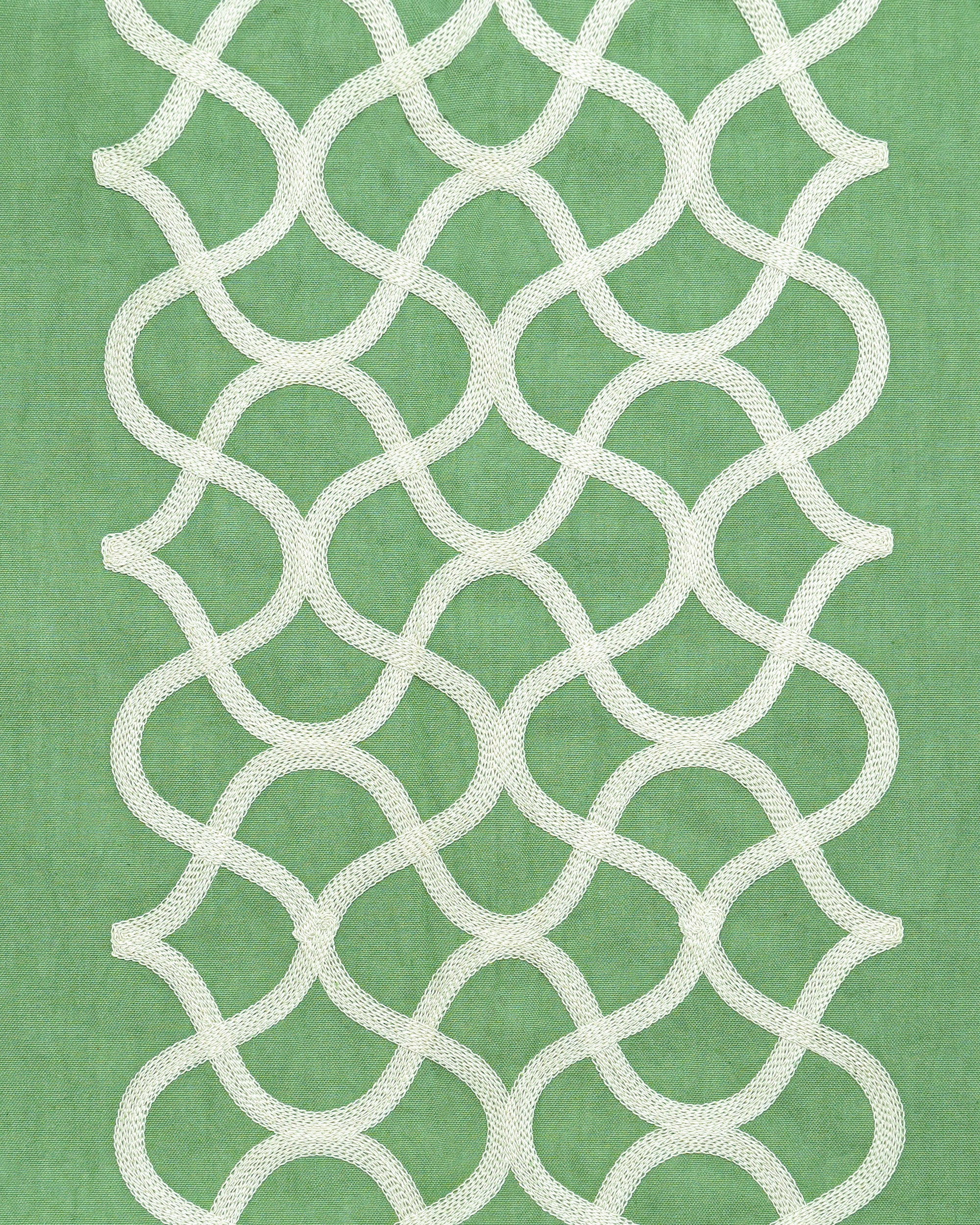 White geometric lattice pattern on a green tablecloth