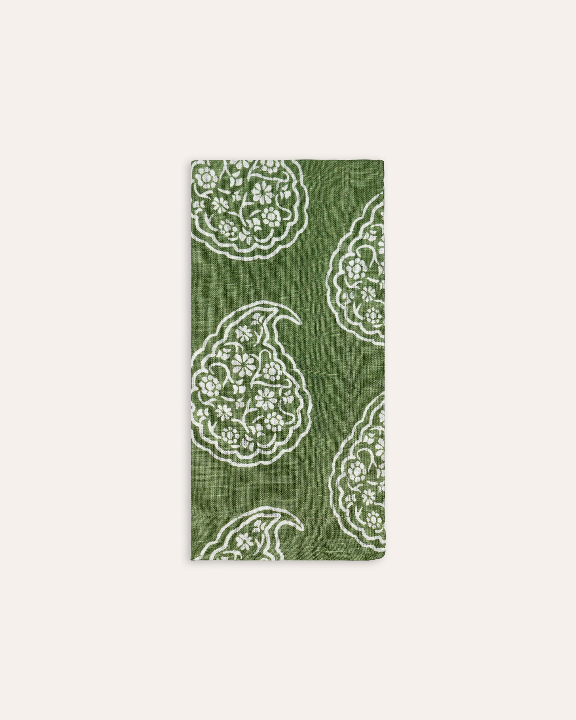 Green and white floral paisley individual napkin on a taupe background