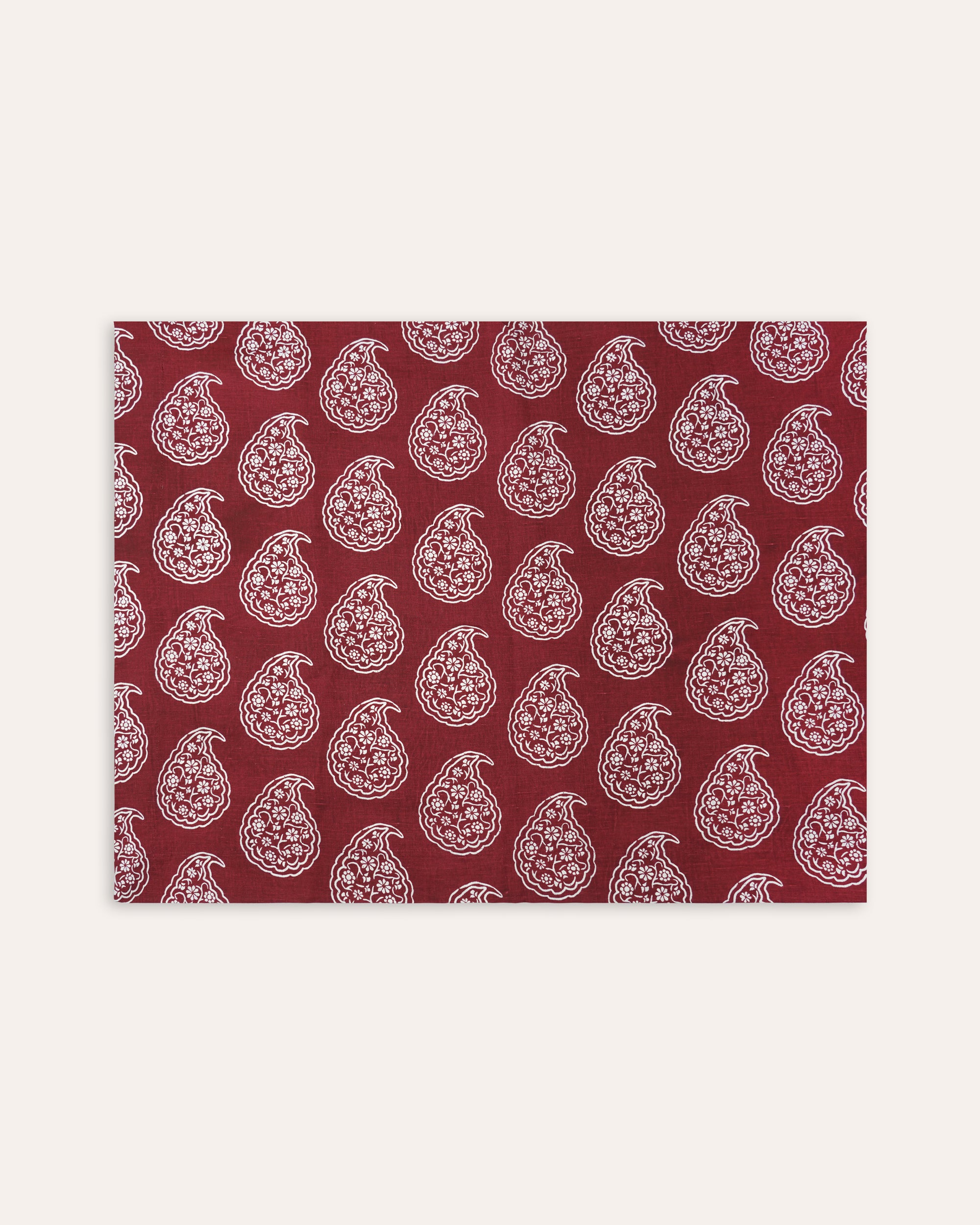 Red tablecloth with white paisley pattern on a white background