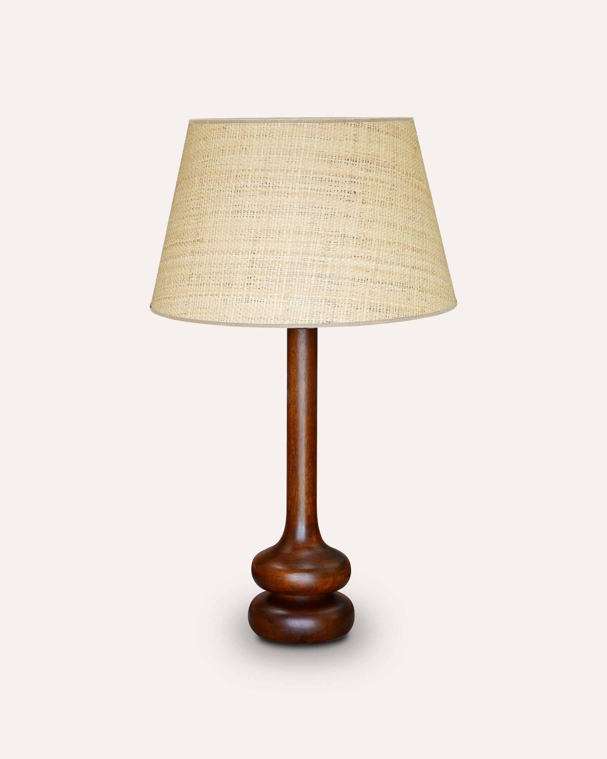 Pyaz table lamp with a wooden base and beige lampshade on a white background