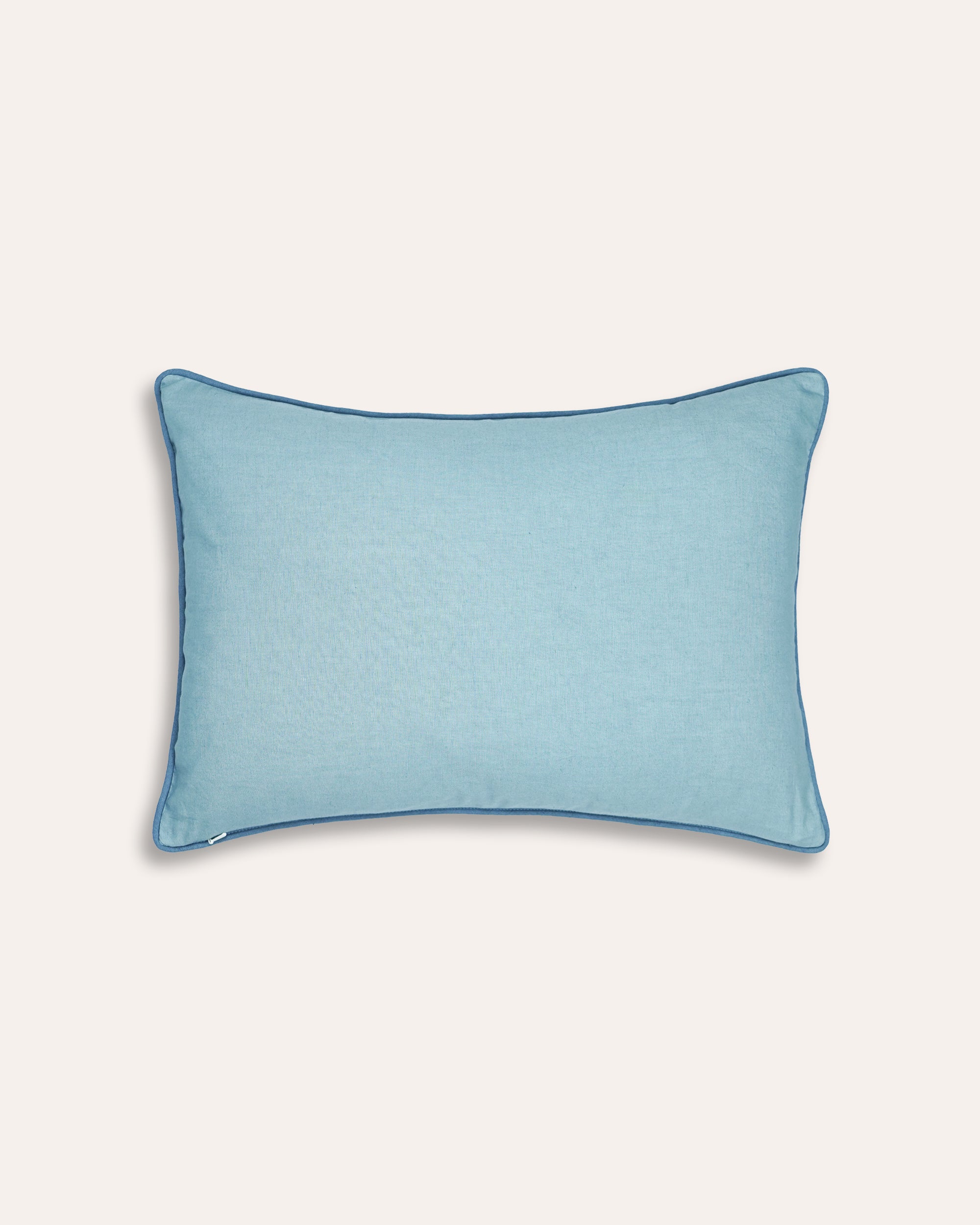 Blue rectangular cushion back on a taupe background