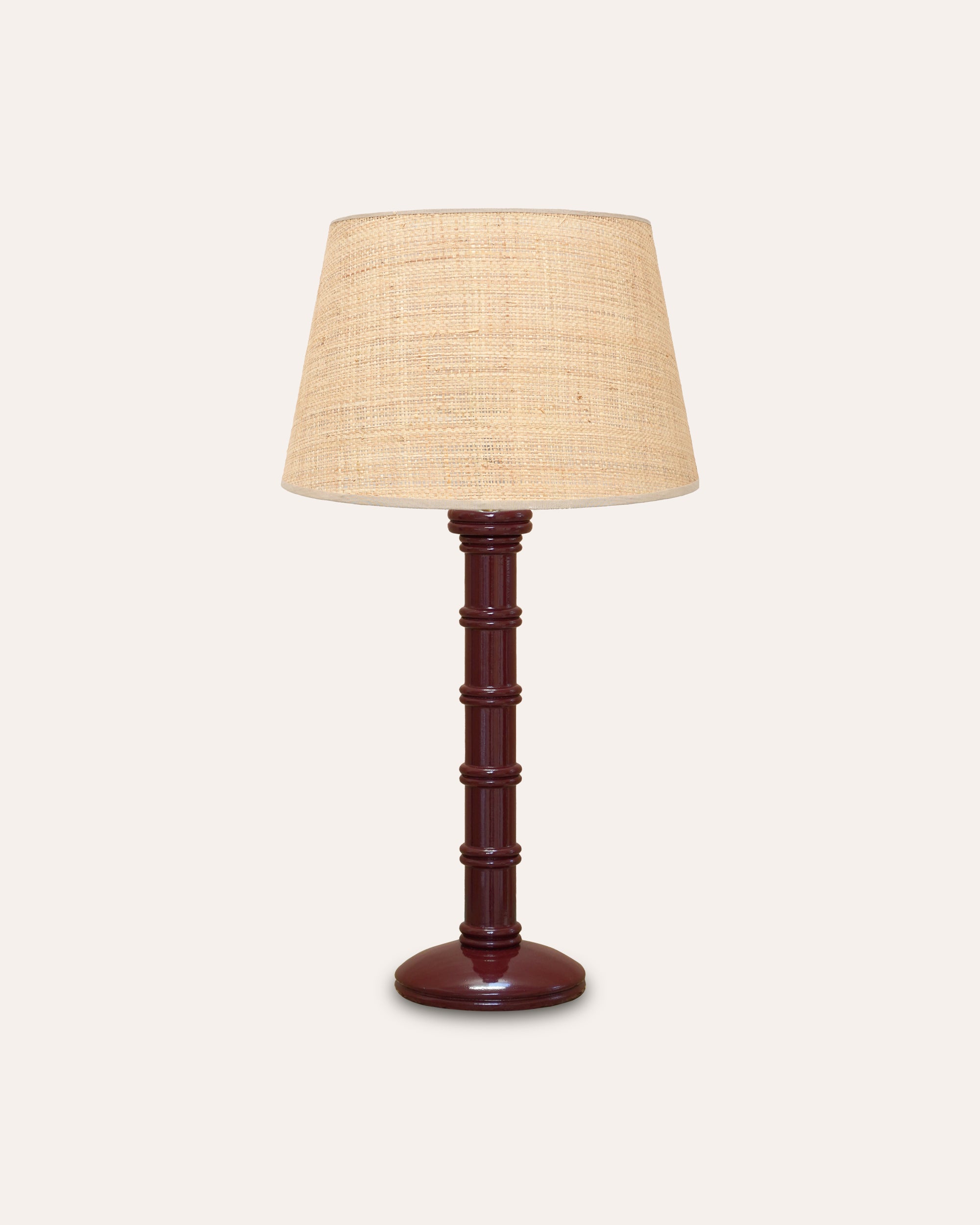 Table lamp with a wooden base and beige lampshade on a white background