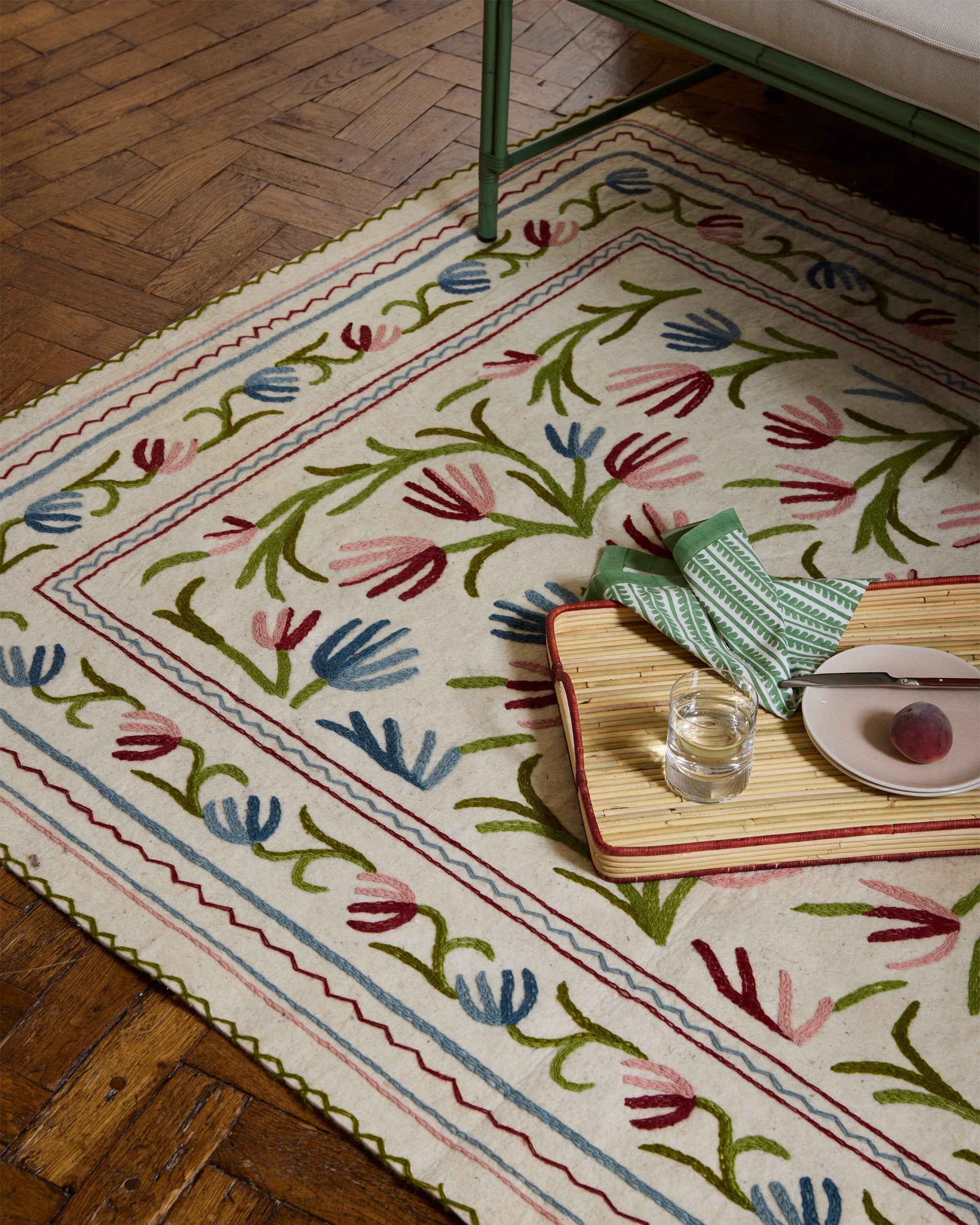 Decorative rug with floral pattern on wooden floor