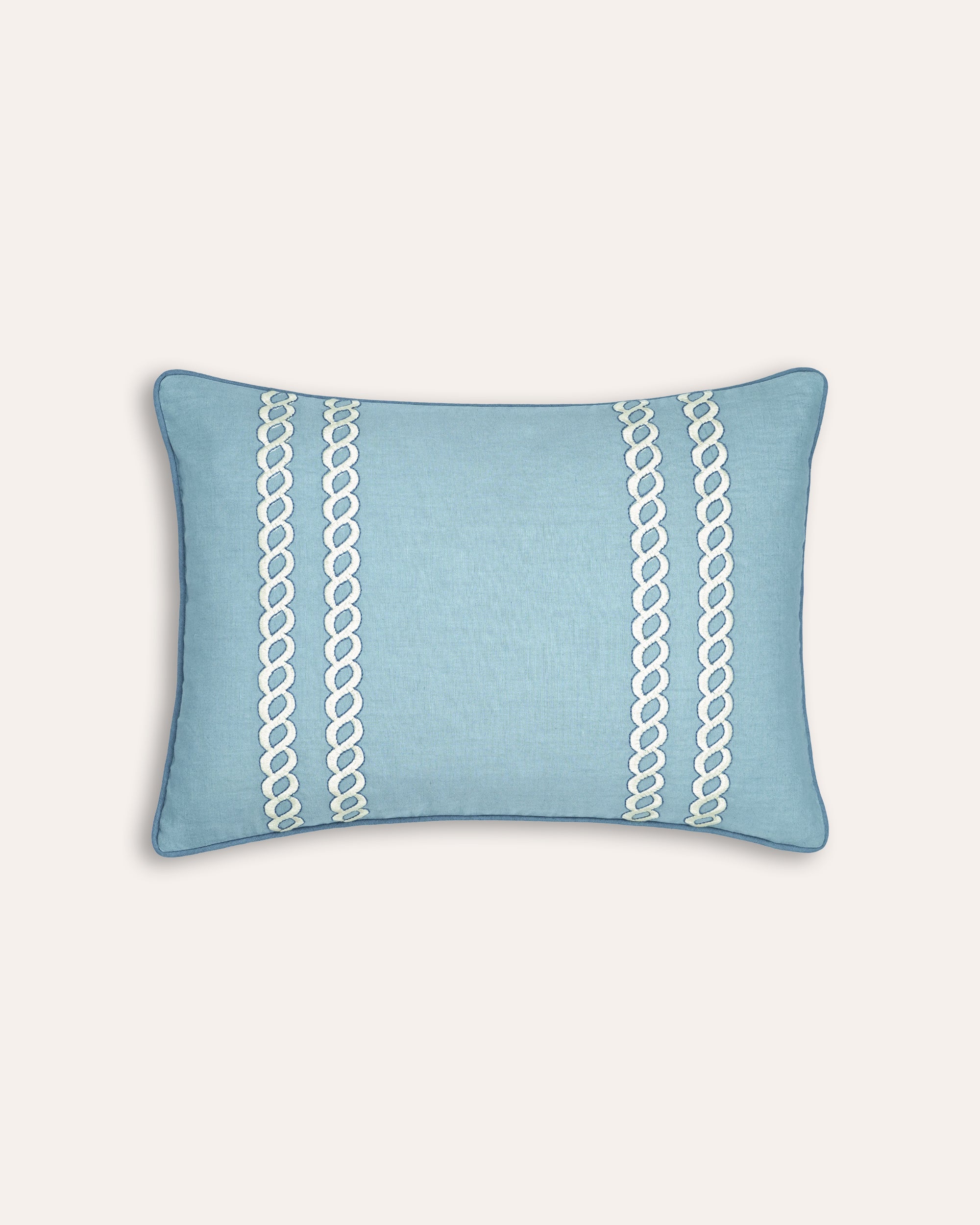 Blue rectangular cushion with white chain pattern on a light grey background