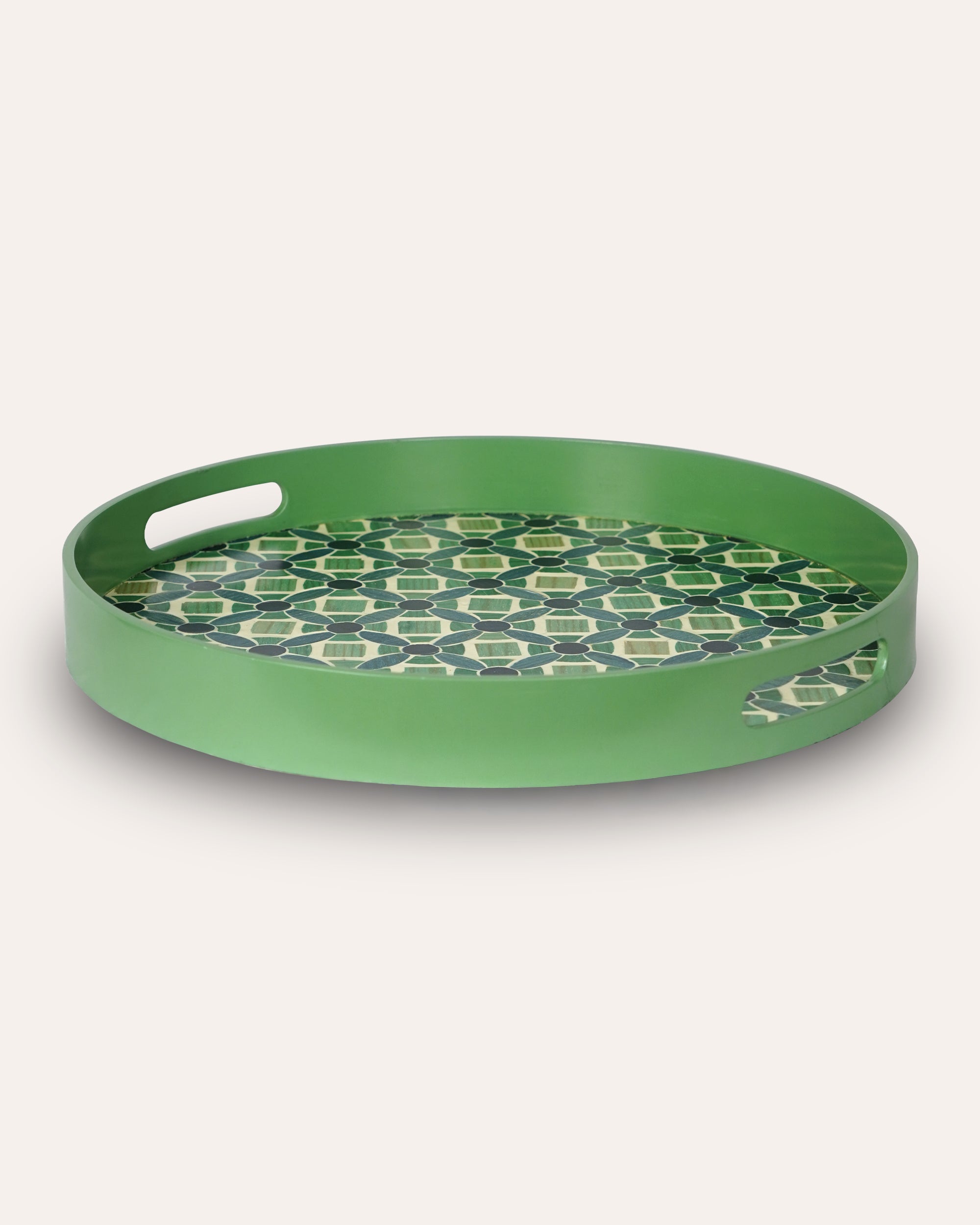 Green decorative tray with a geometric pattern on a white background