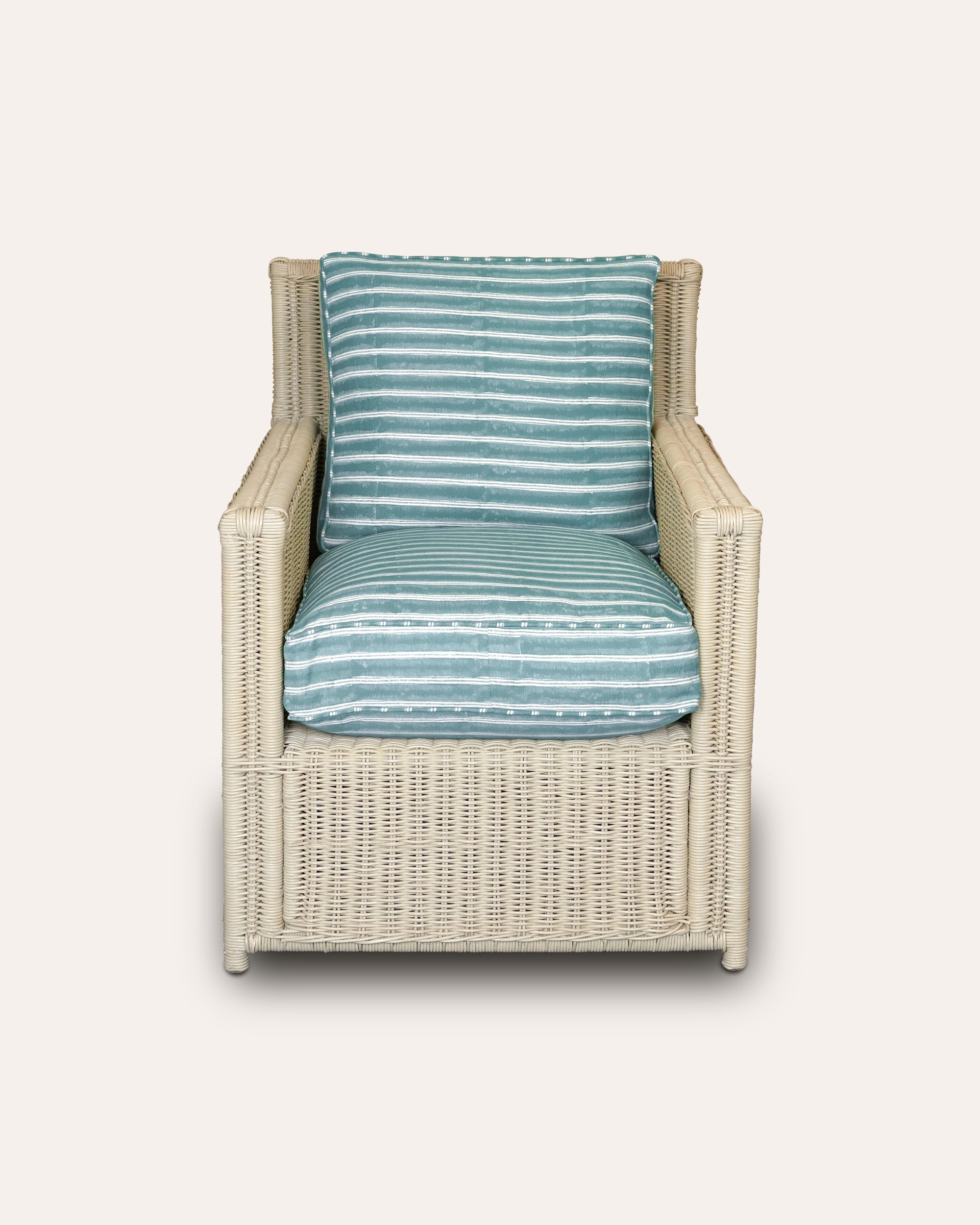 Wicker chair with blue striped cushions on a white background
