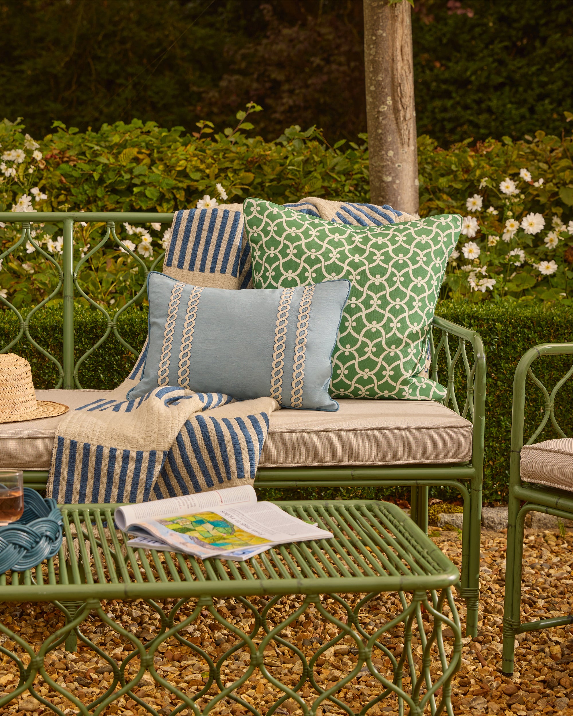Outdoor patio set with cushions and a magazine on a table