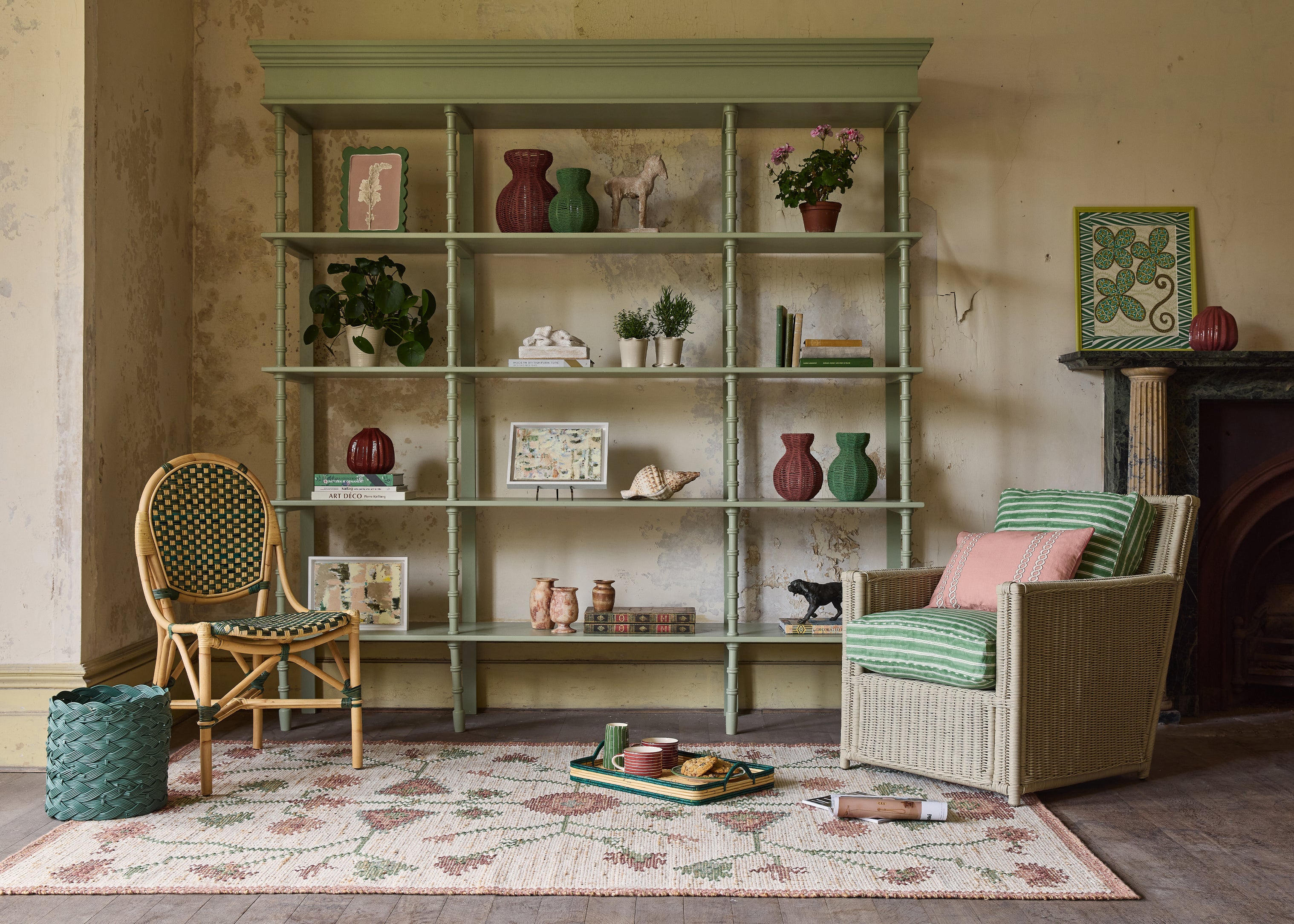 Living room with a bookshelf, chairs, and decorative items.