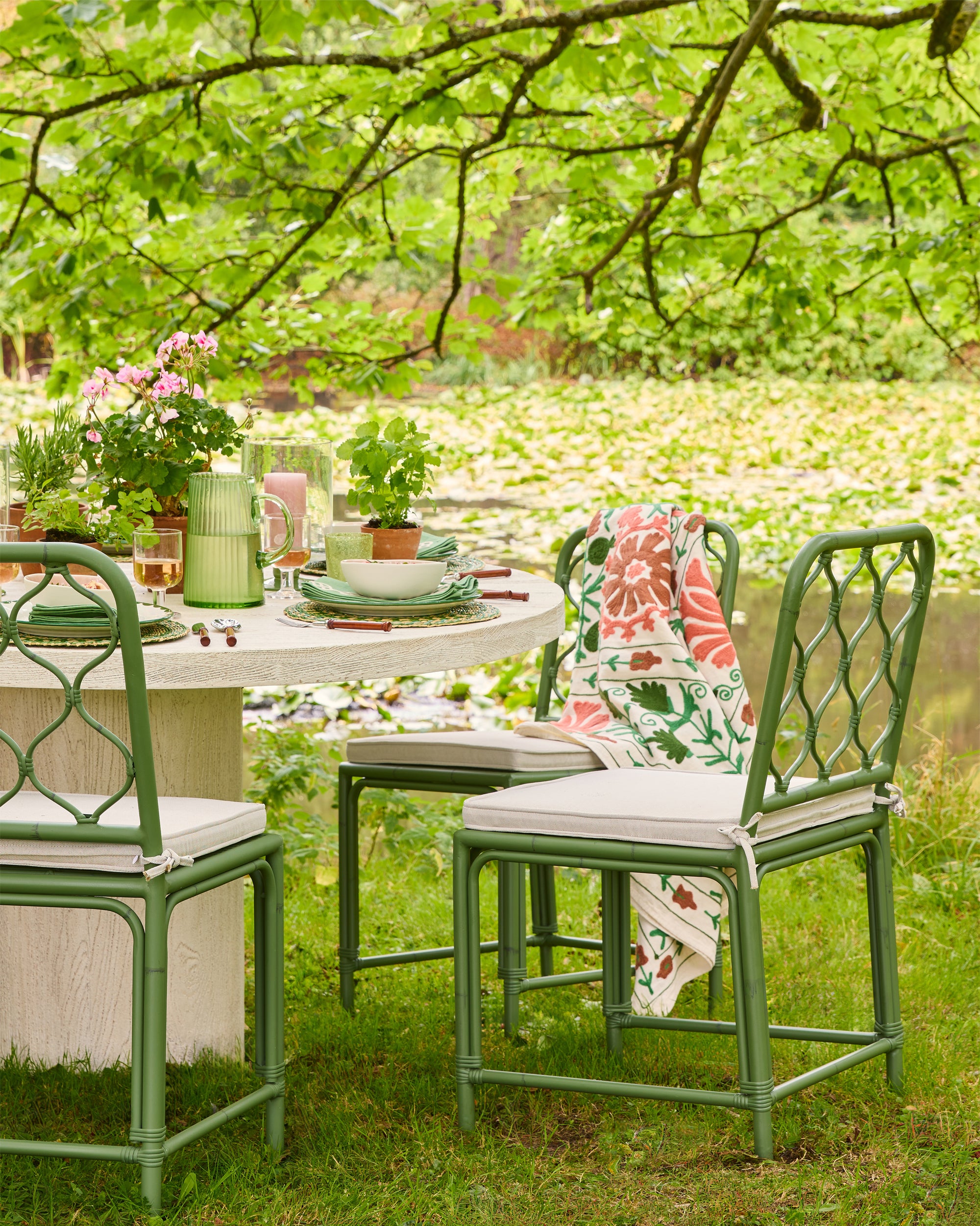 Outdoor setting with green chairs and table in a garden
