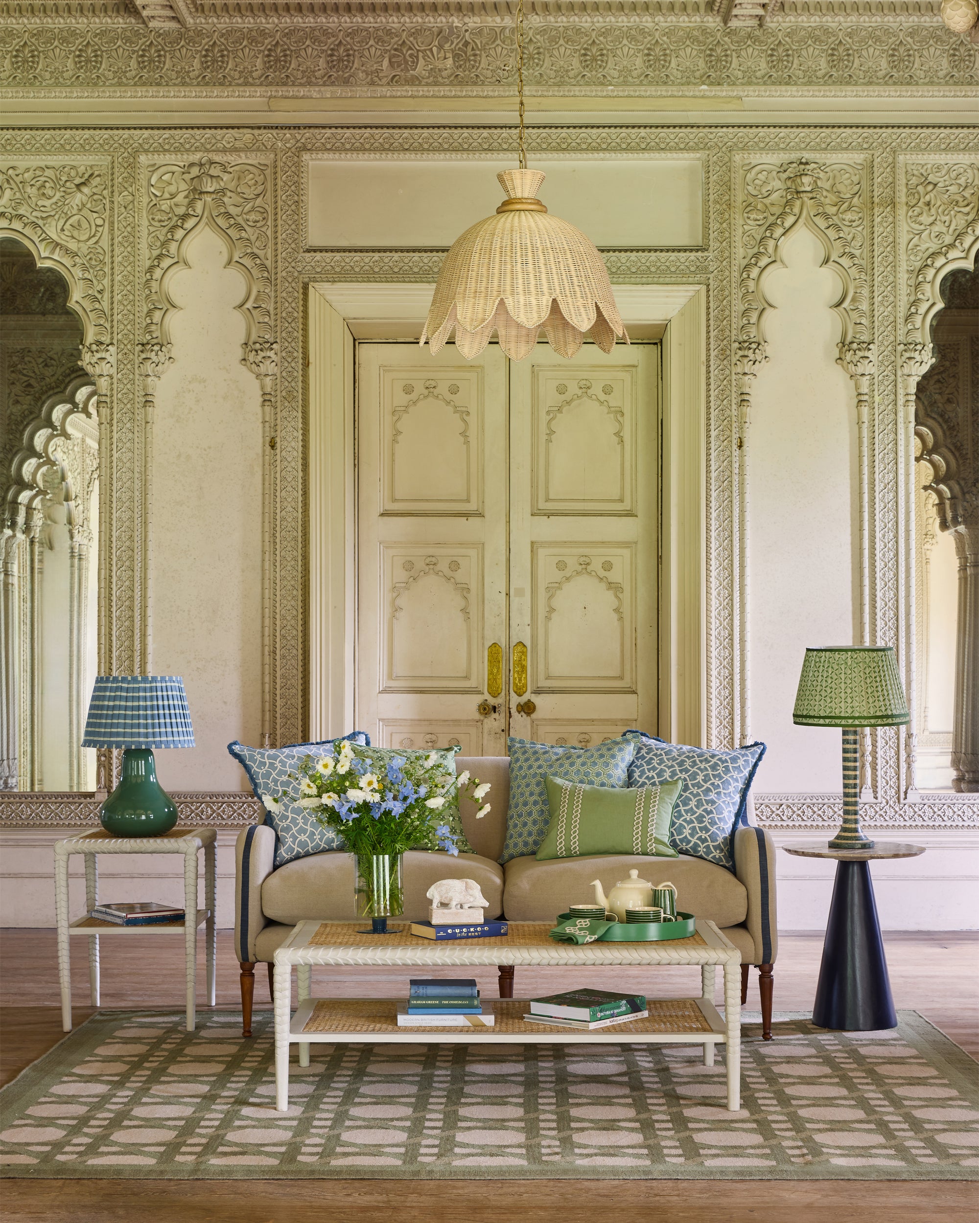 Decorative living room with ornate walls, a beige sofa, and decorative items.