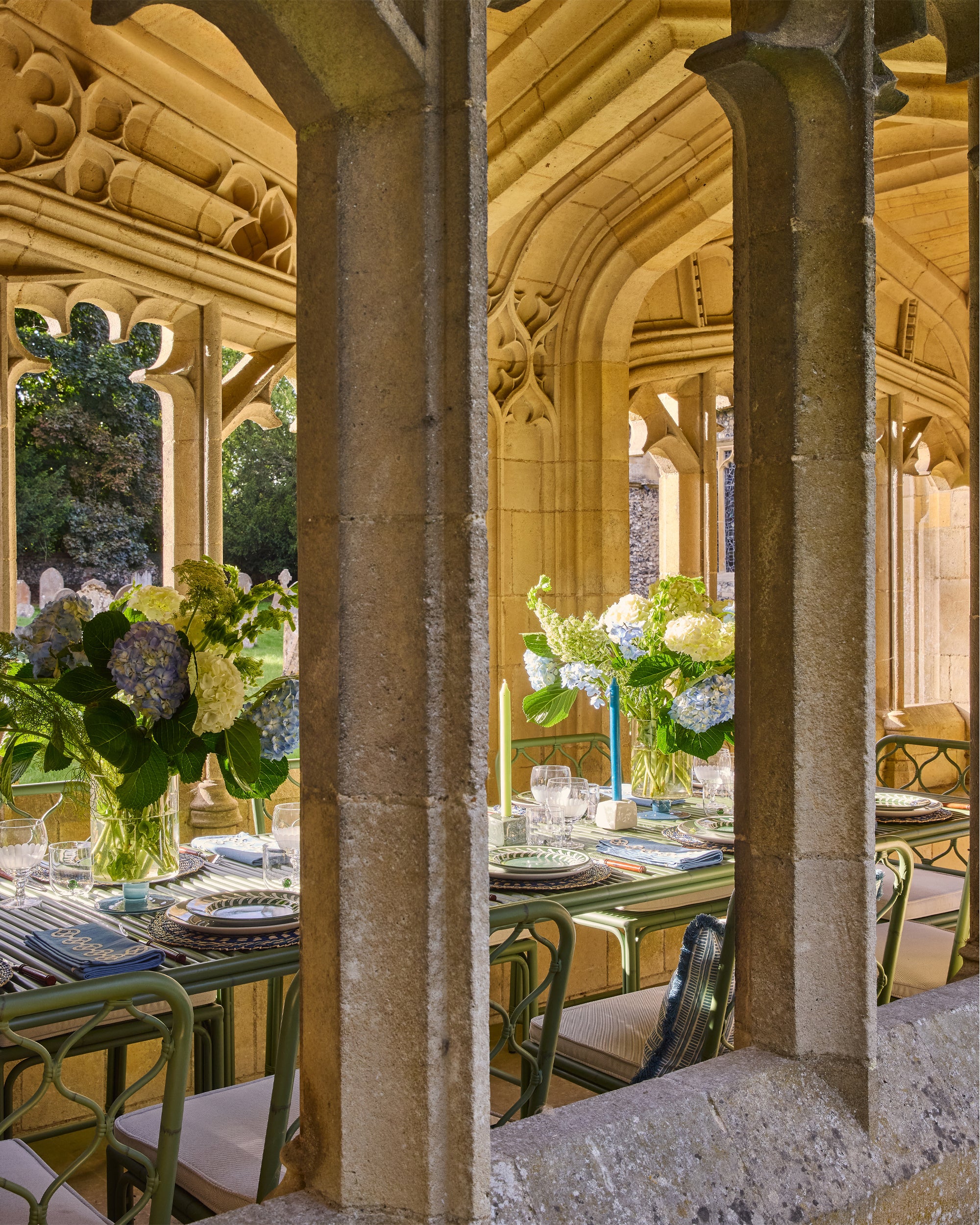 Dining area with tables and chairs under stone arches