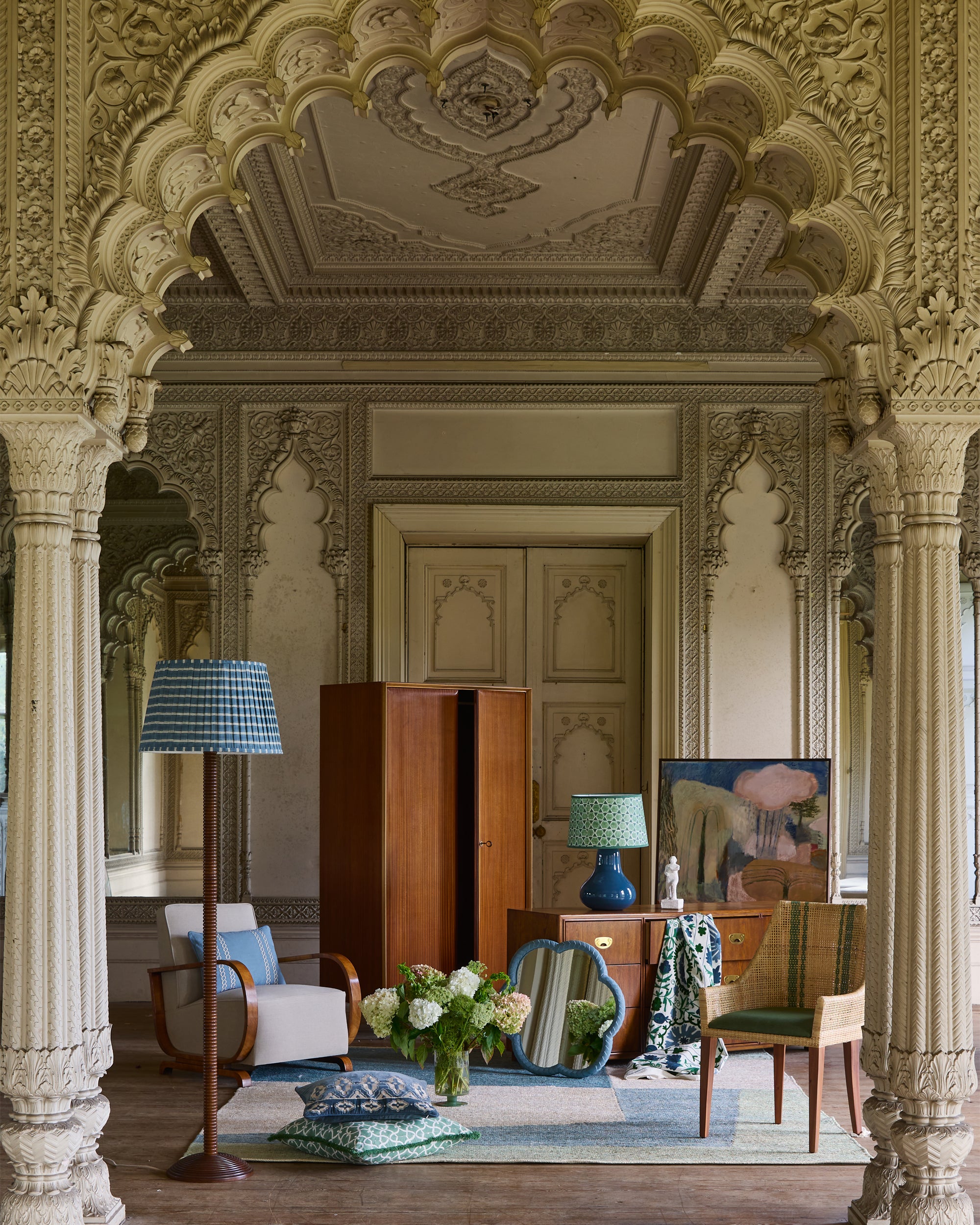 Decorative interior with ornate archway, furniture, and decor items.