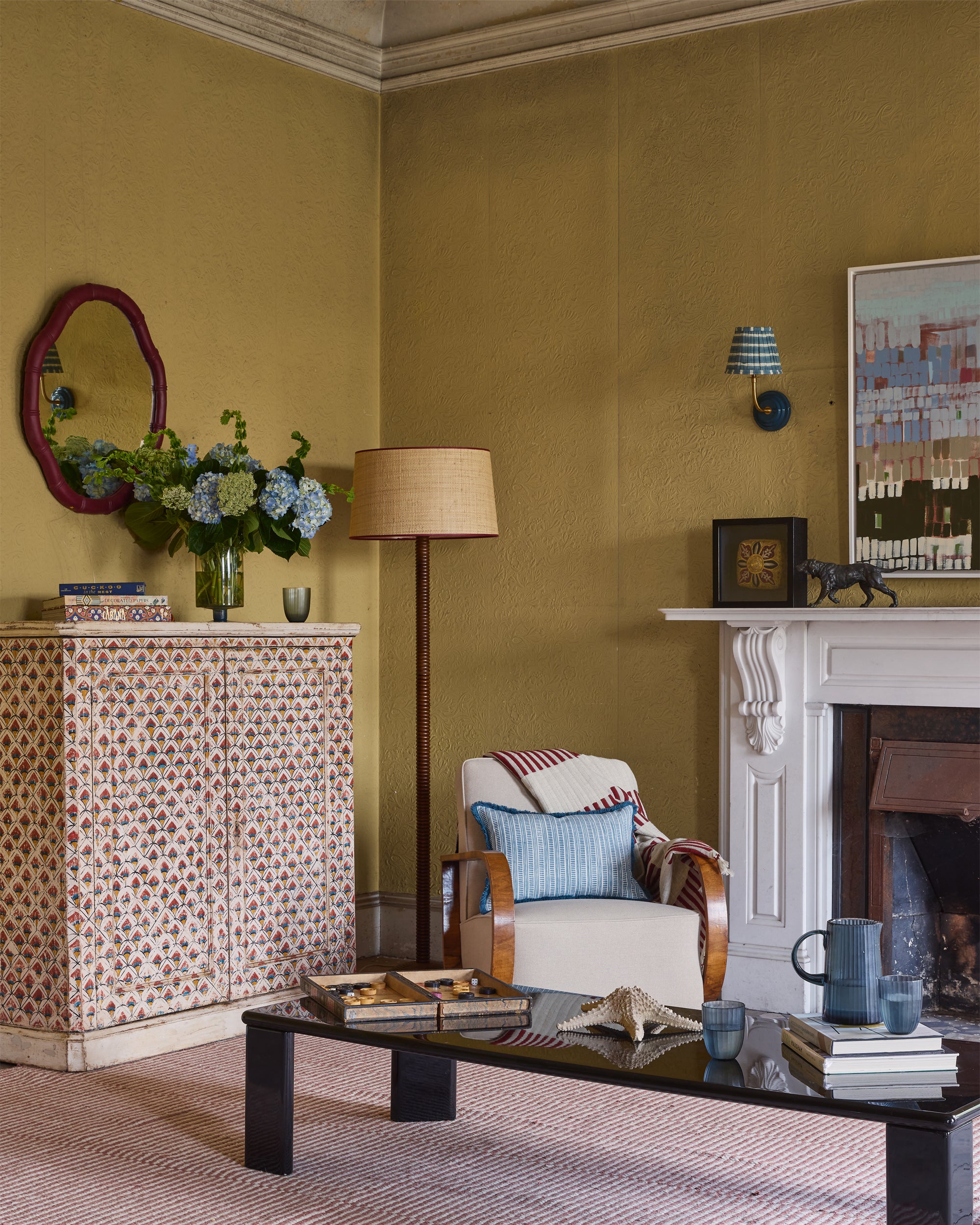Living room with patterned sideboard, armchair, and coffee table.