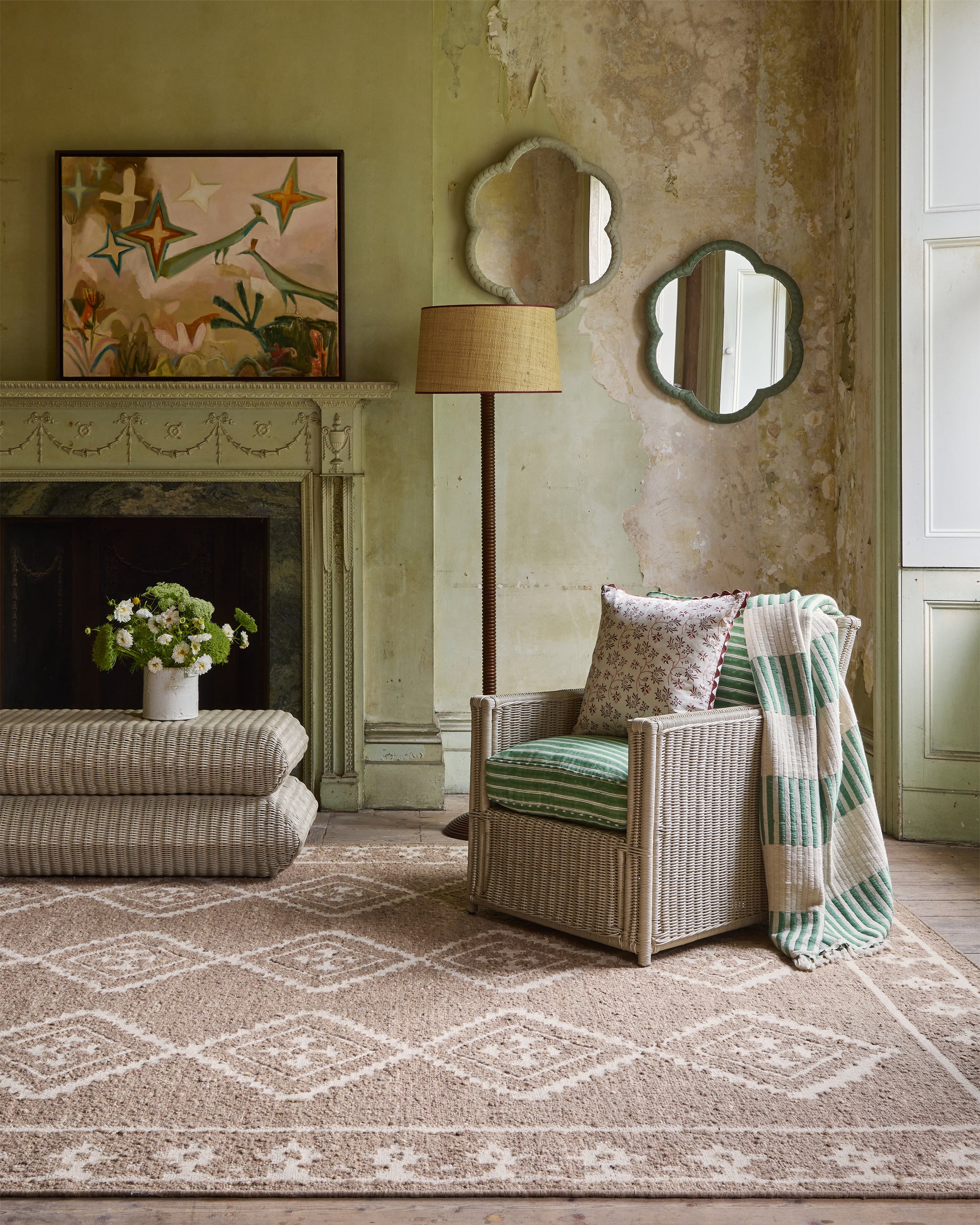 Living room with wicker armchair, patterned rug, and decorative elements.