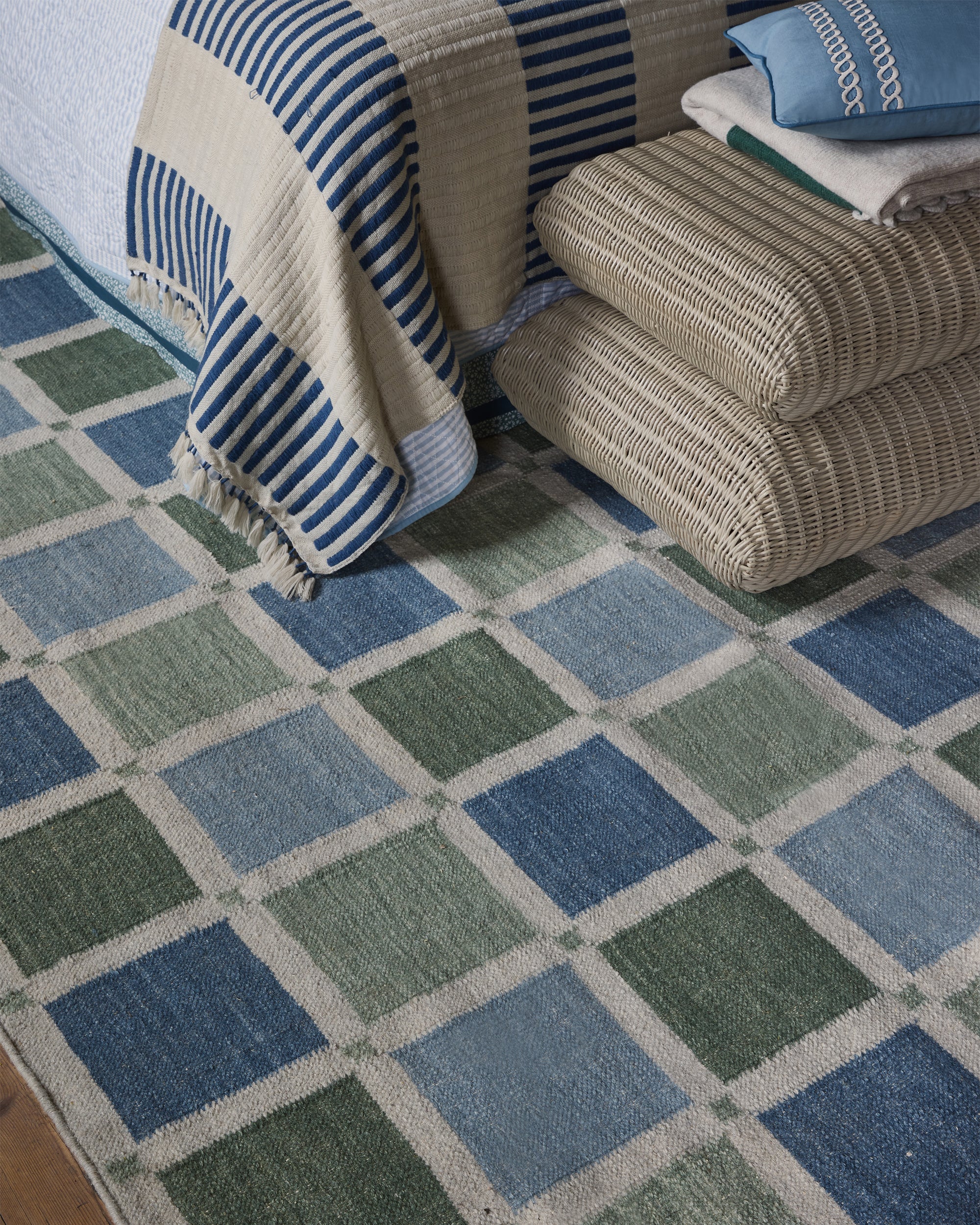 Patterned rug with blue and green squares in a living room setting.