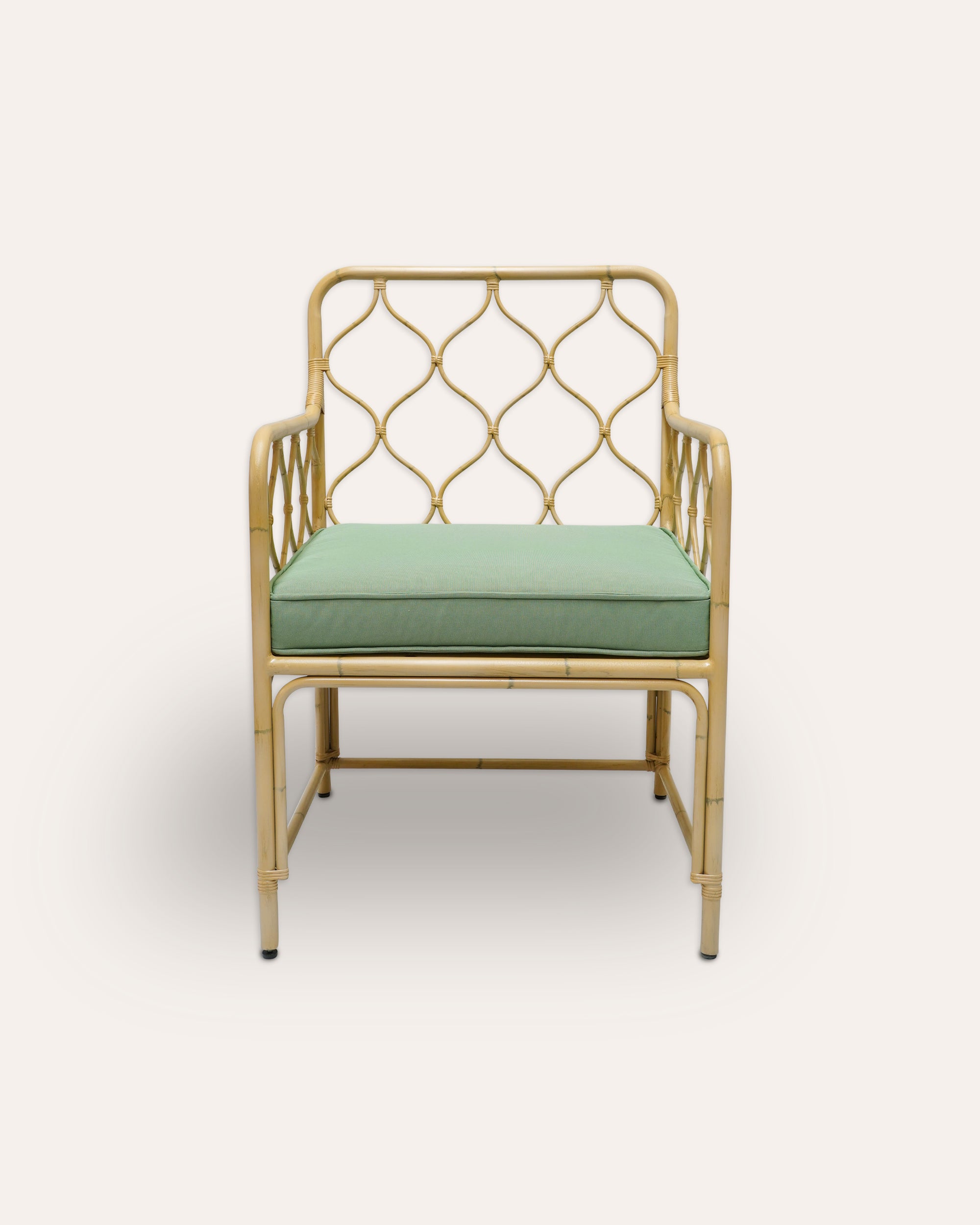 Natural armchair with green cushion on a white background