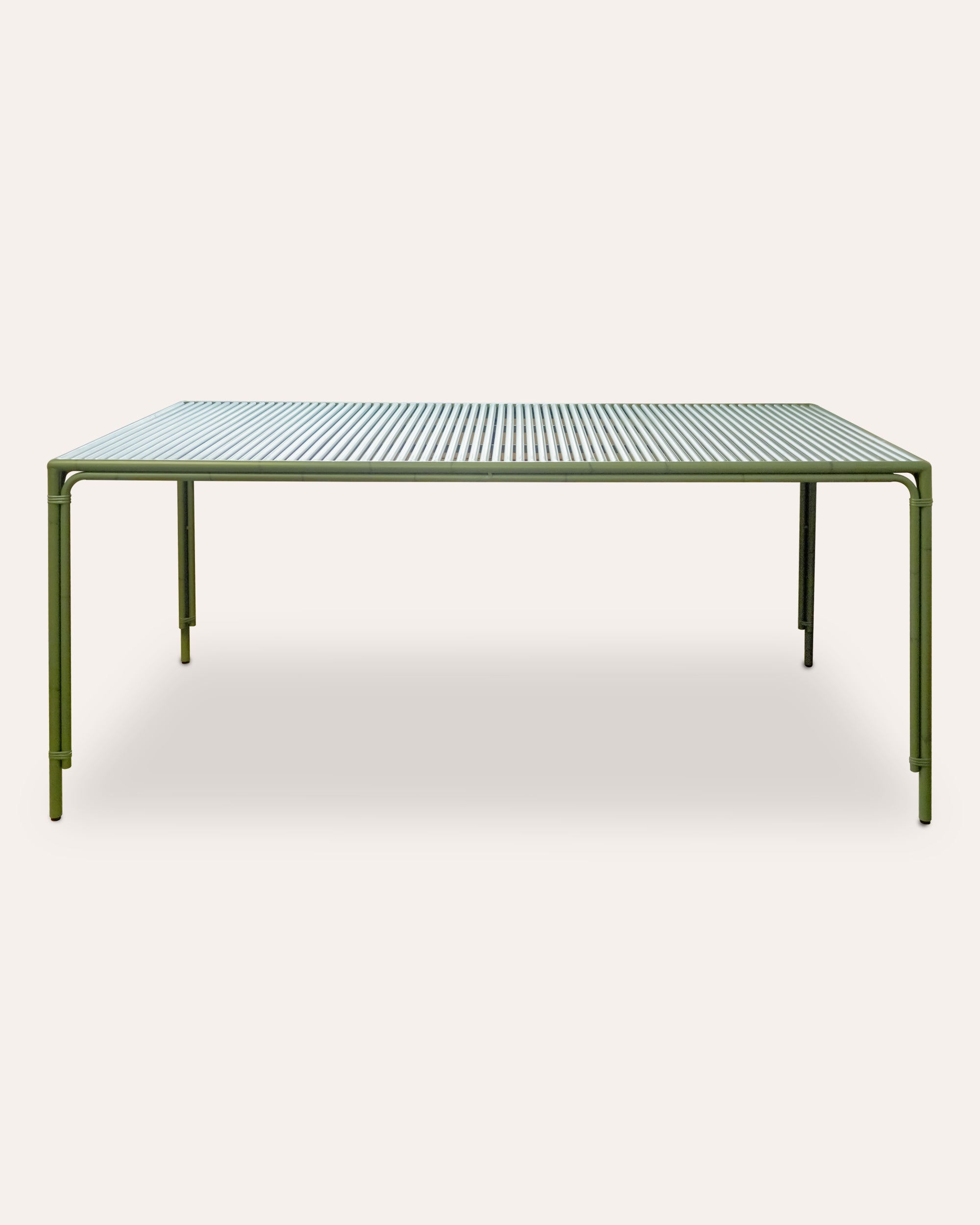 Green rectangular dining table on a taupe background