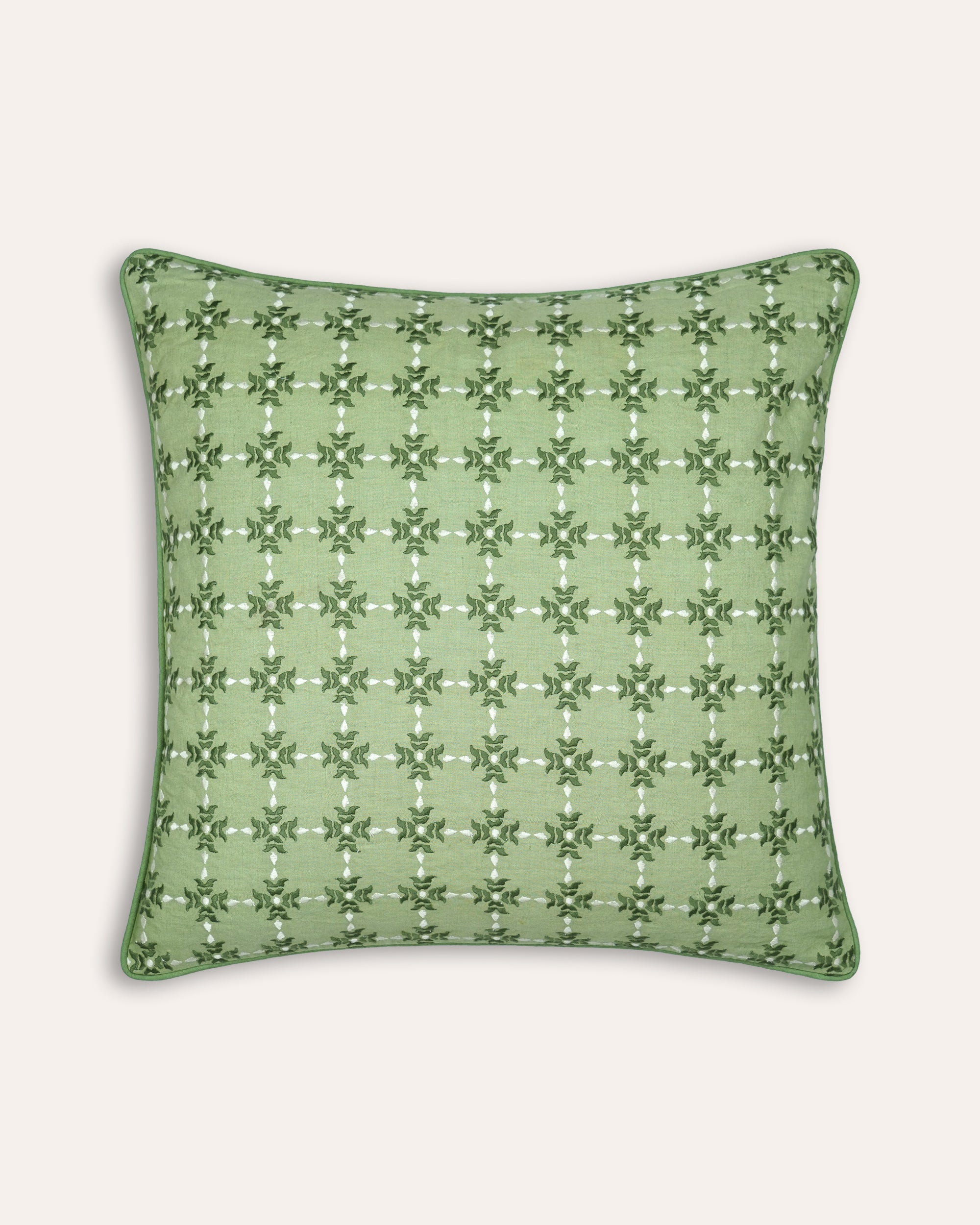 Green embroidered square cushion on a white background