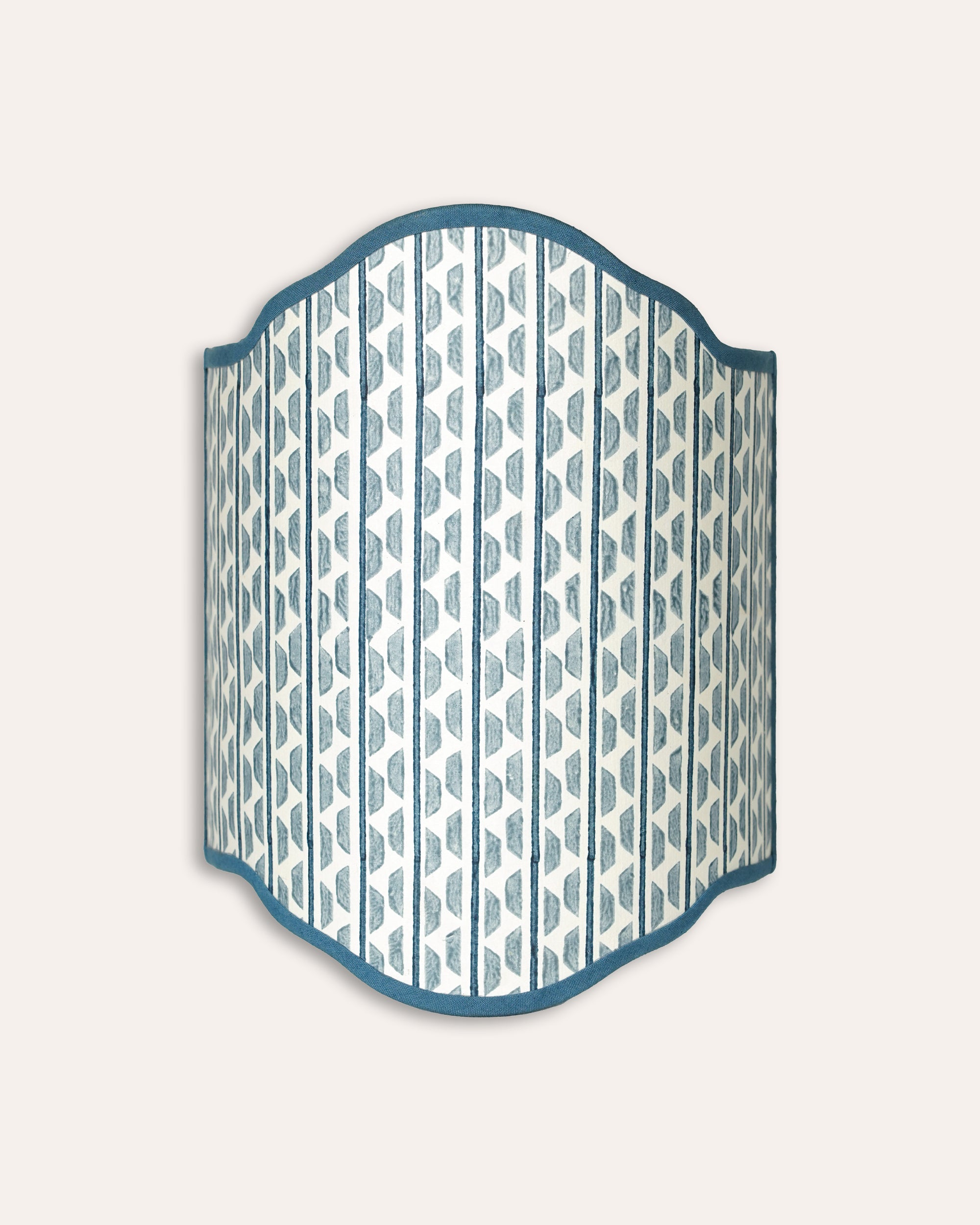 Decorative wall light shade with blue and white geometric pattern on a light grey background