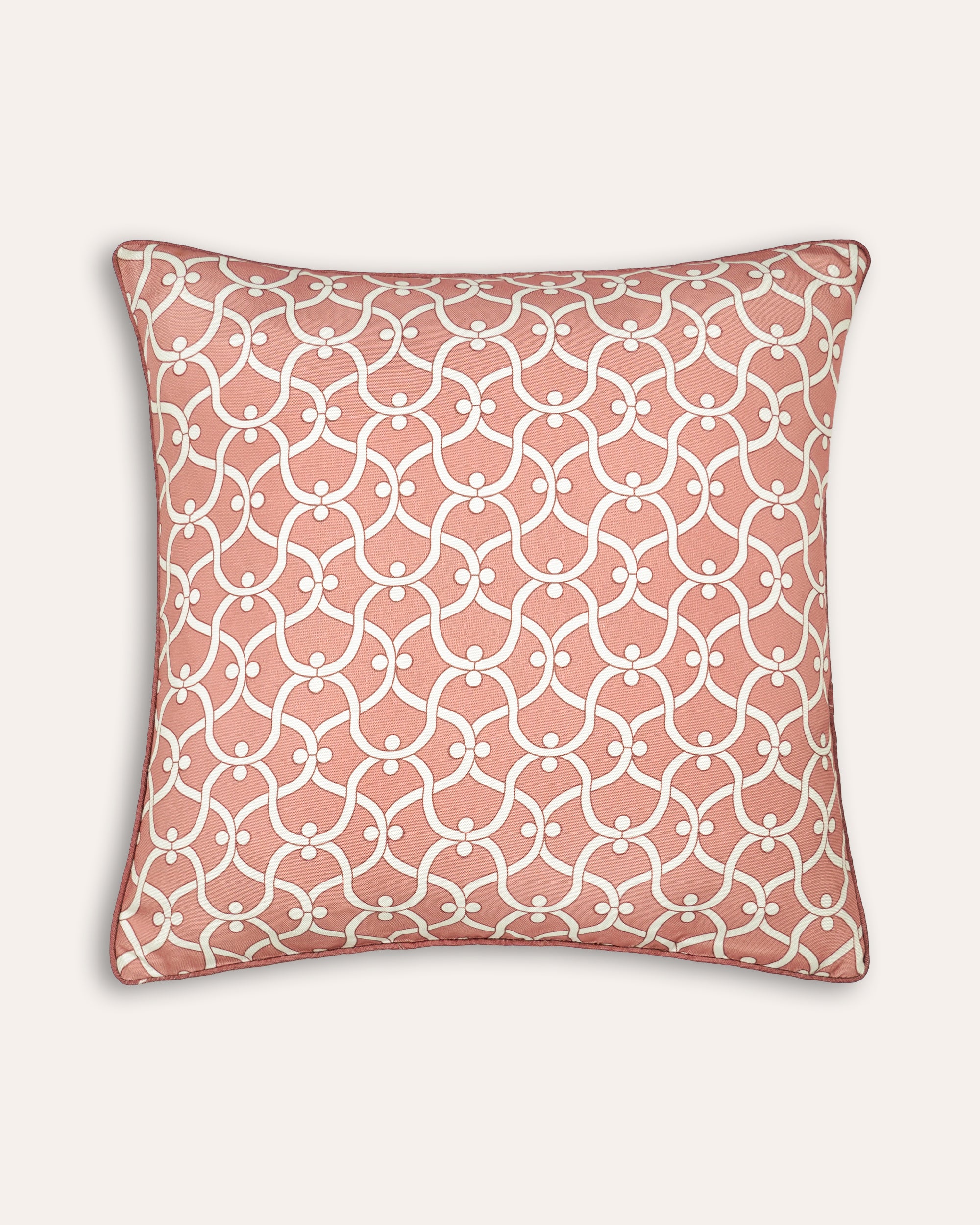 Decorative pink outdoor square cushion with a geometric pattern on a plain background
