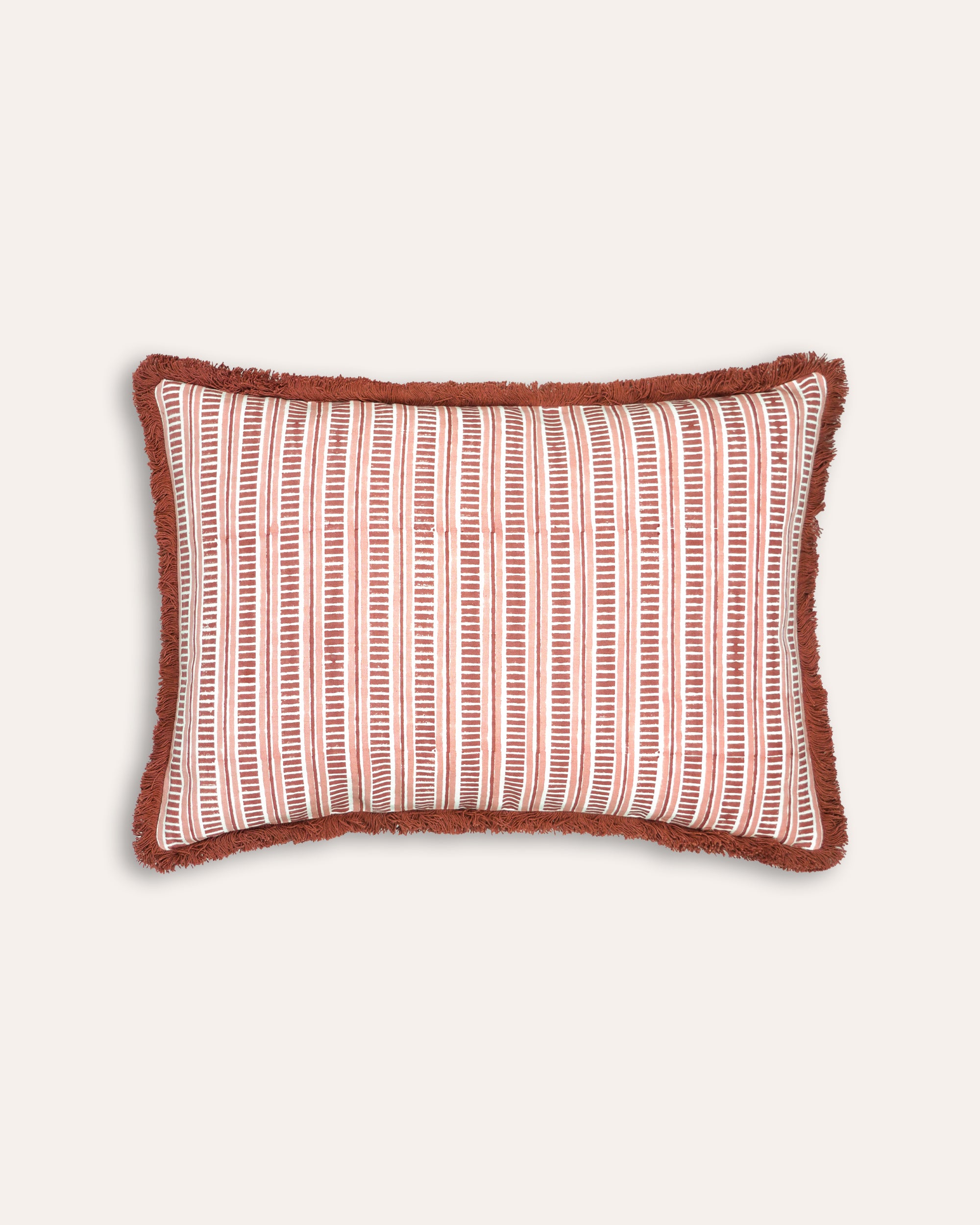 Rectangular block printed cushion with red and white striped pattern on a light beige background