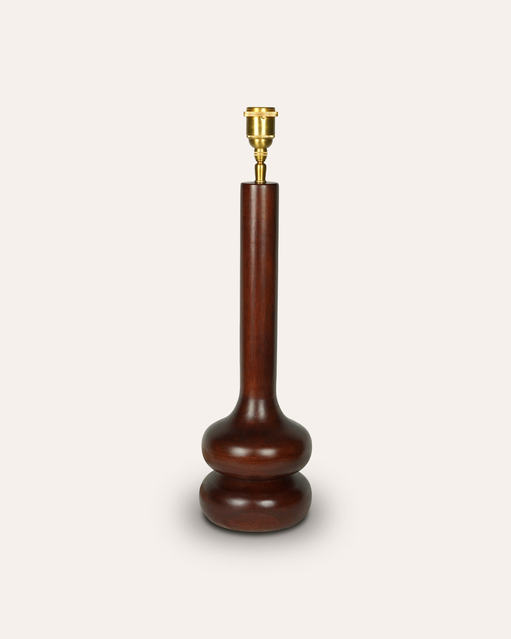 Wooden lamp base with brass fitting on a white background