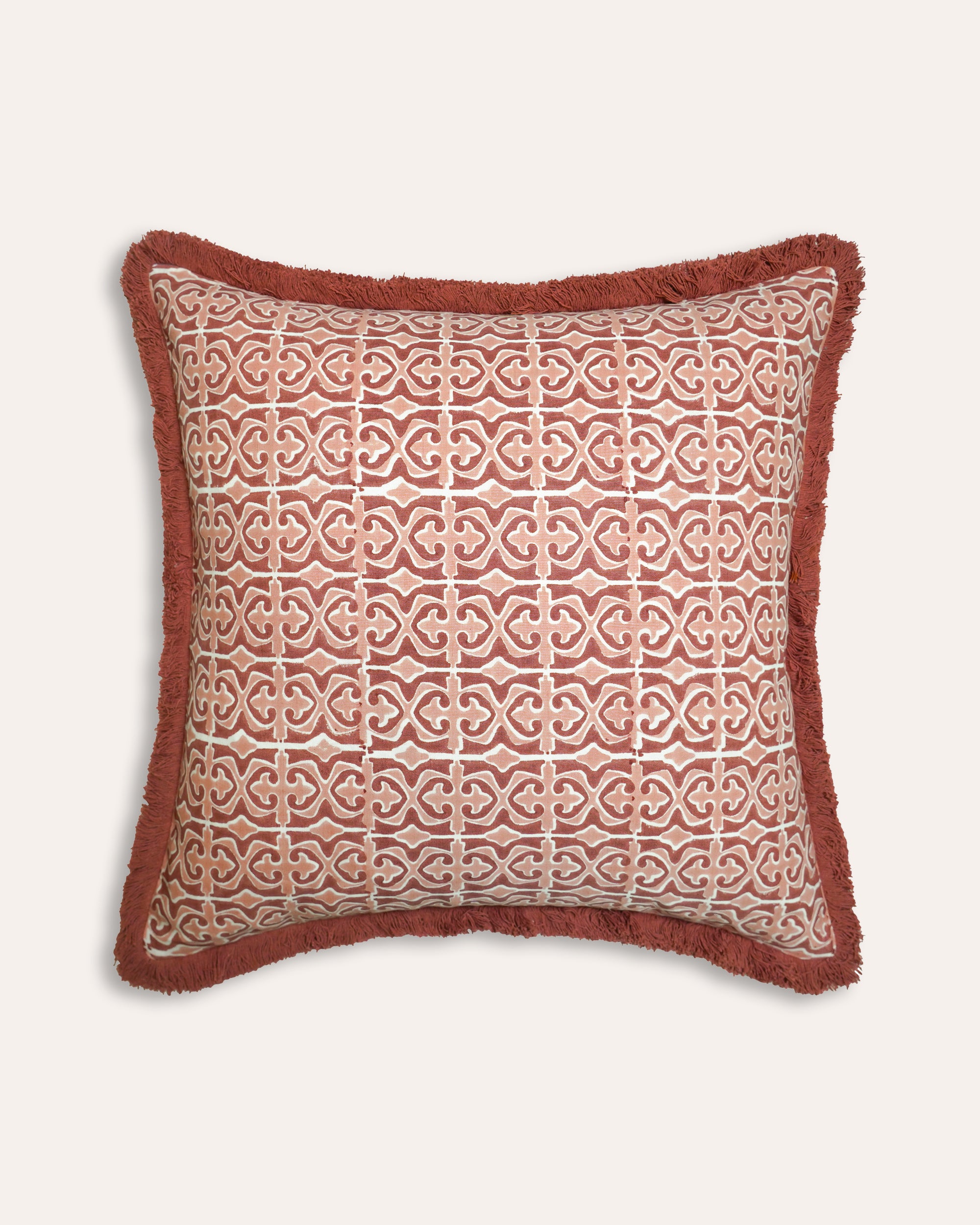 Pink and red Santa Clara block print cushion with a geometric pattern and red fringe - Birdie Fortescue soft furnishings
