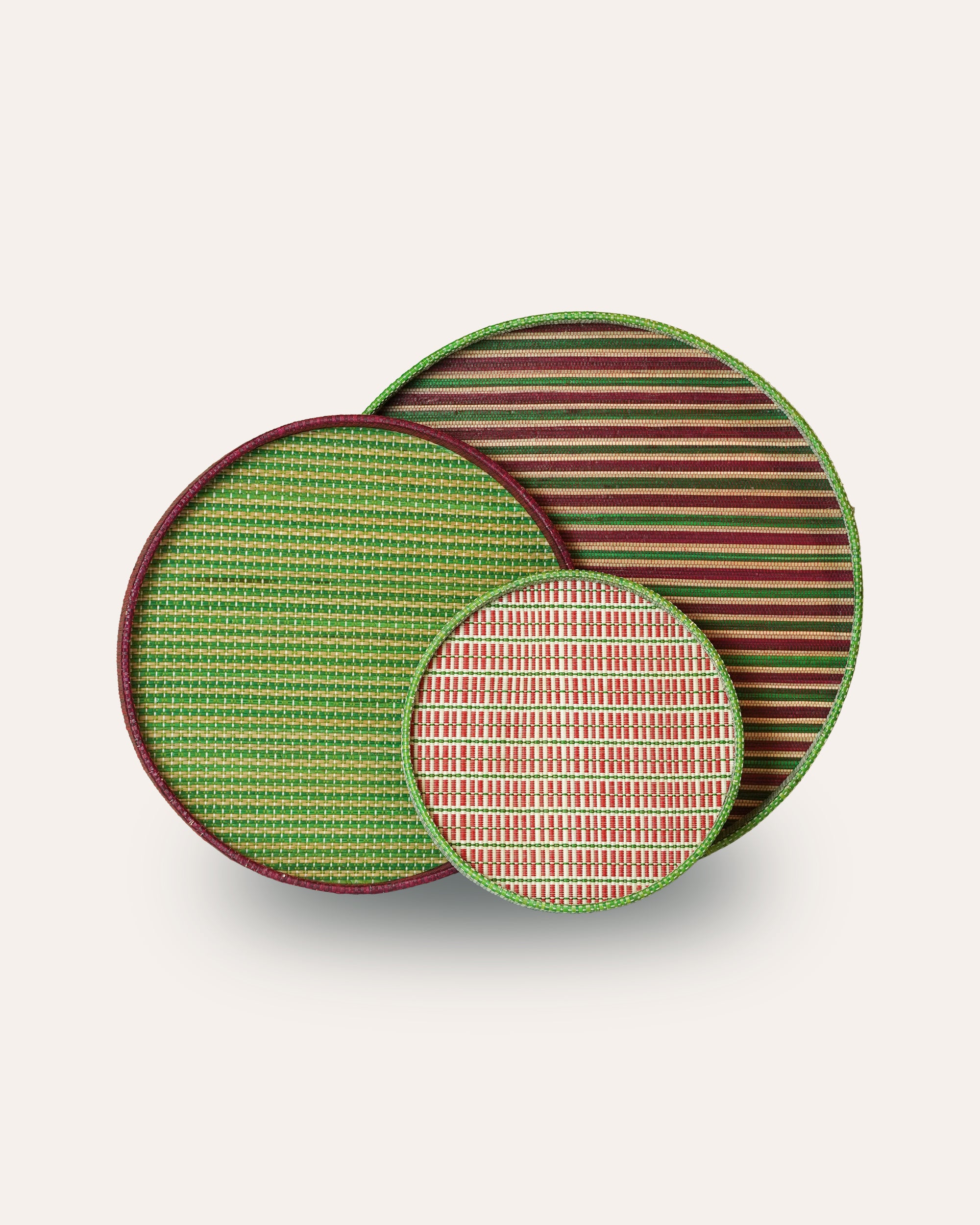 Set of three decorative plates with green, red, and striped patterns on a white background
