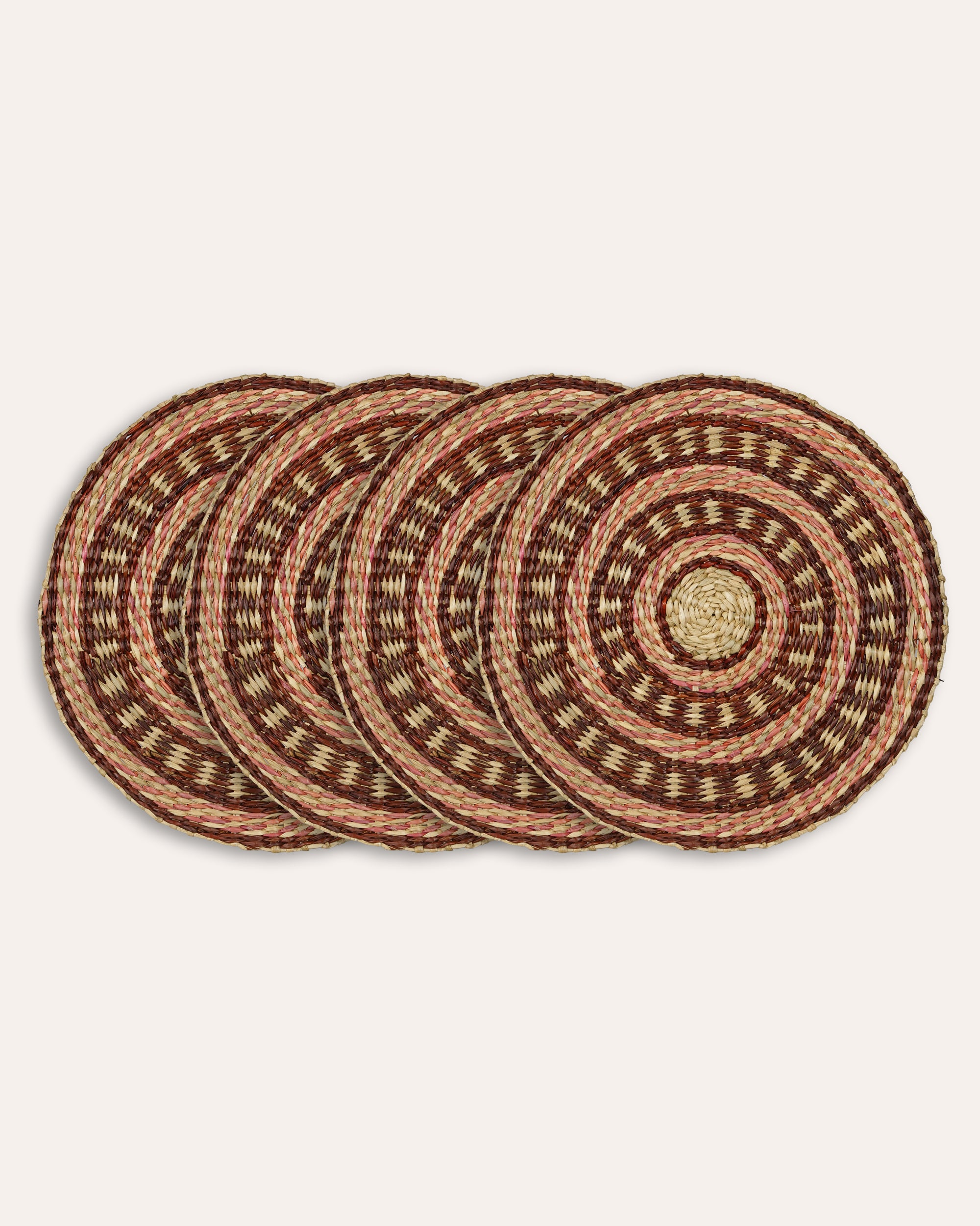 Set of four woven placemats on a beige background