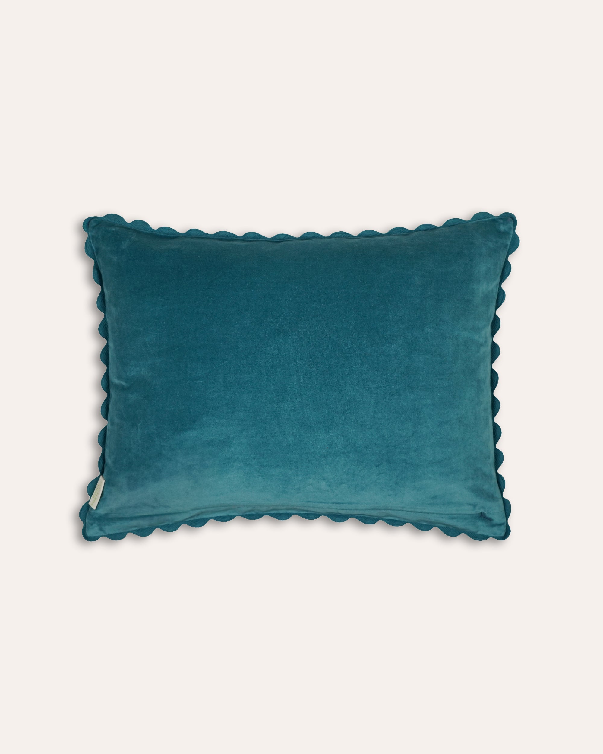 Teal velvet cushion back with scalloped edge on a white background
