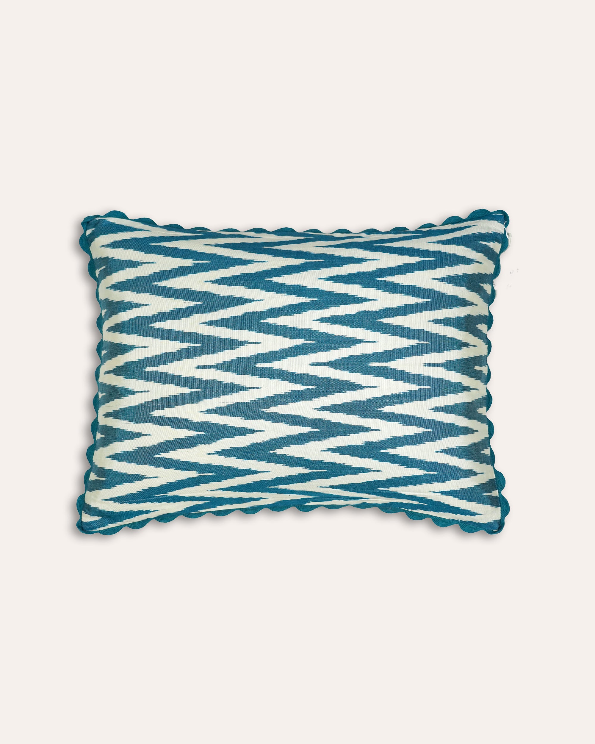 Blue and white zigzag patterned rectangular cushion on a light grey background