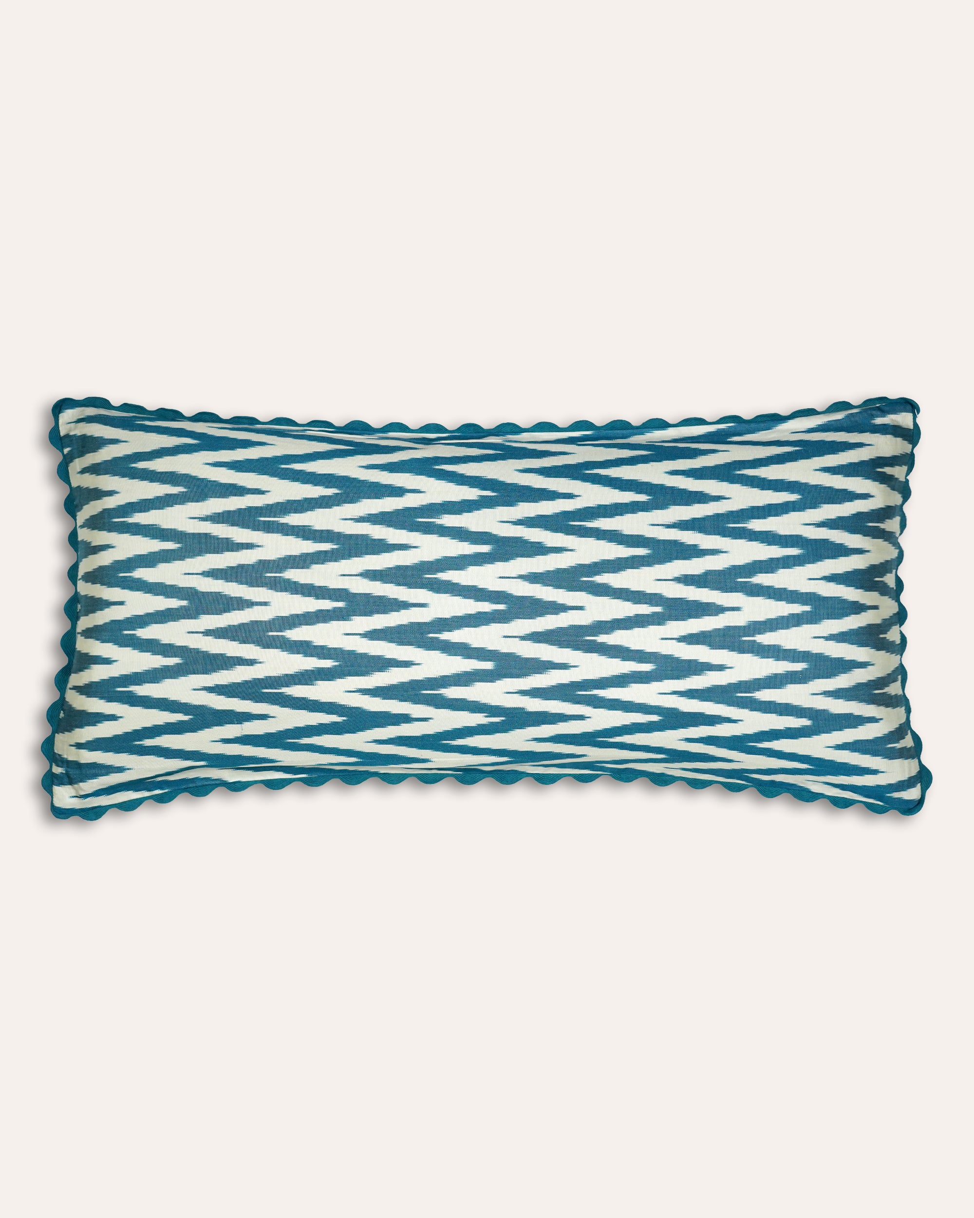 Large blue and white zigzag patterned rectangular cushion on a light grey background