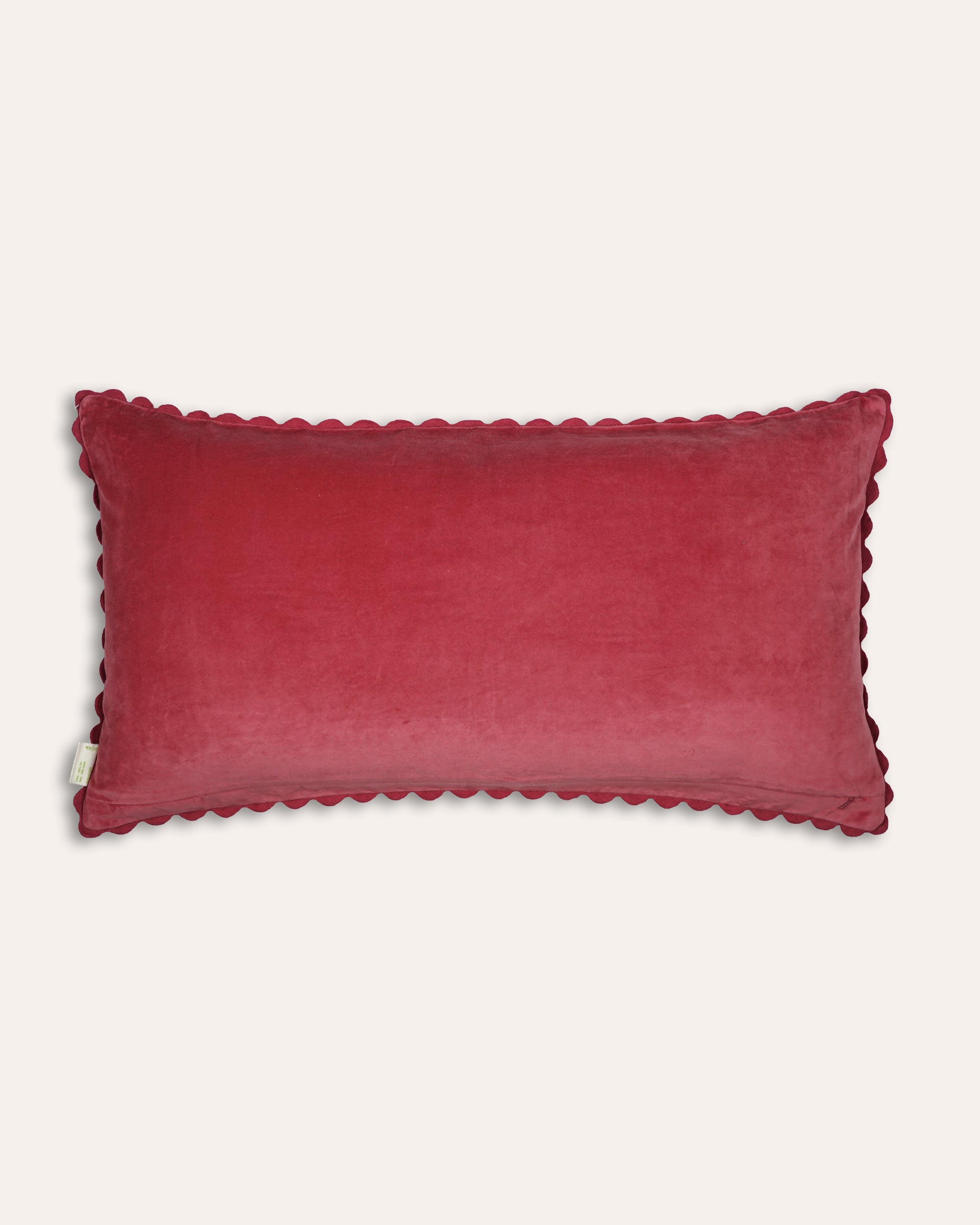 Red velvet cushion back with scalloped edges on a white background
