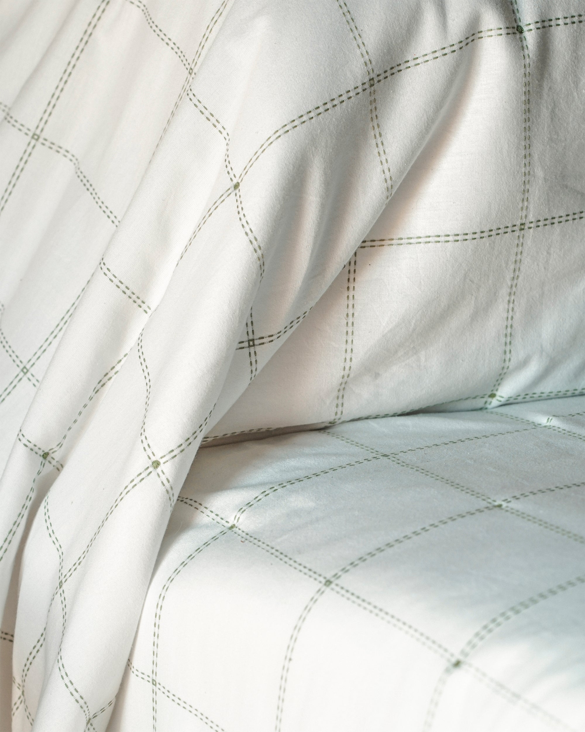 Close-up of quilted fabric with a diamond pattern