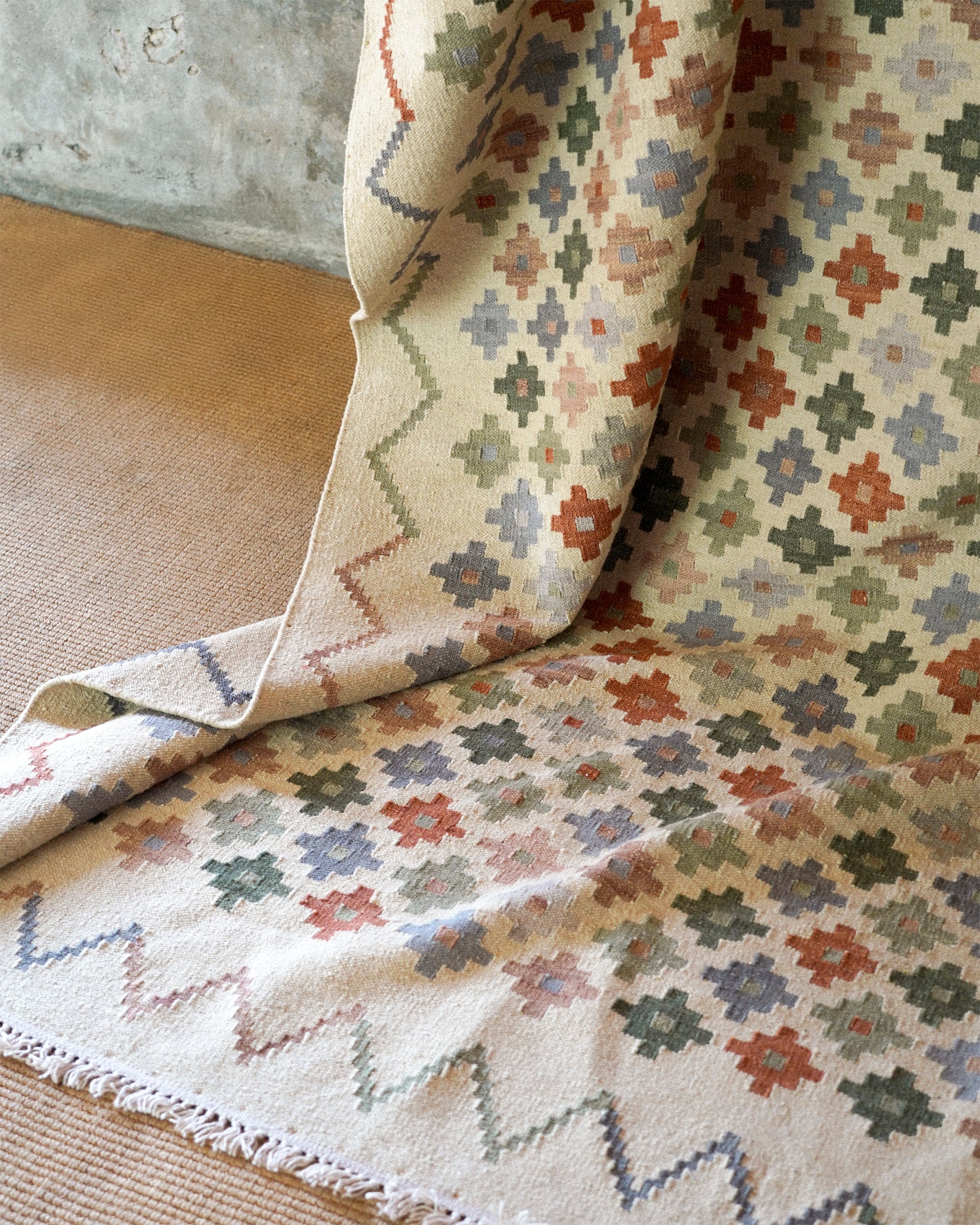 Patterned rug with geometric design on a textured surface