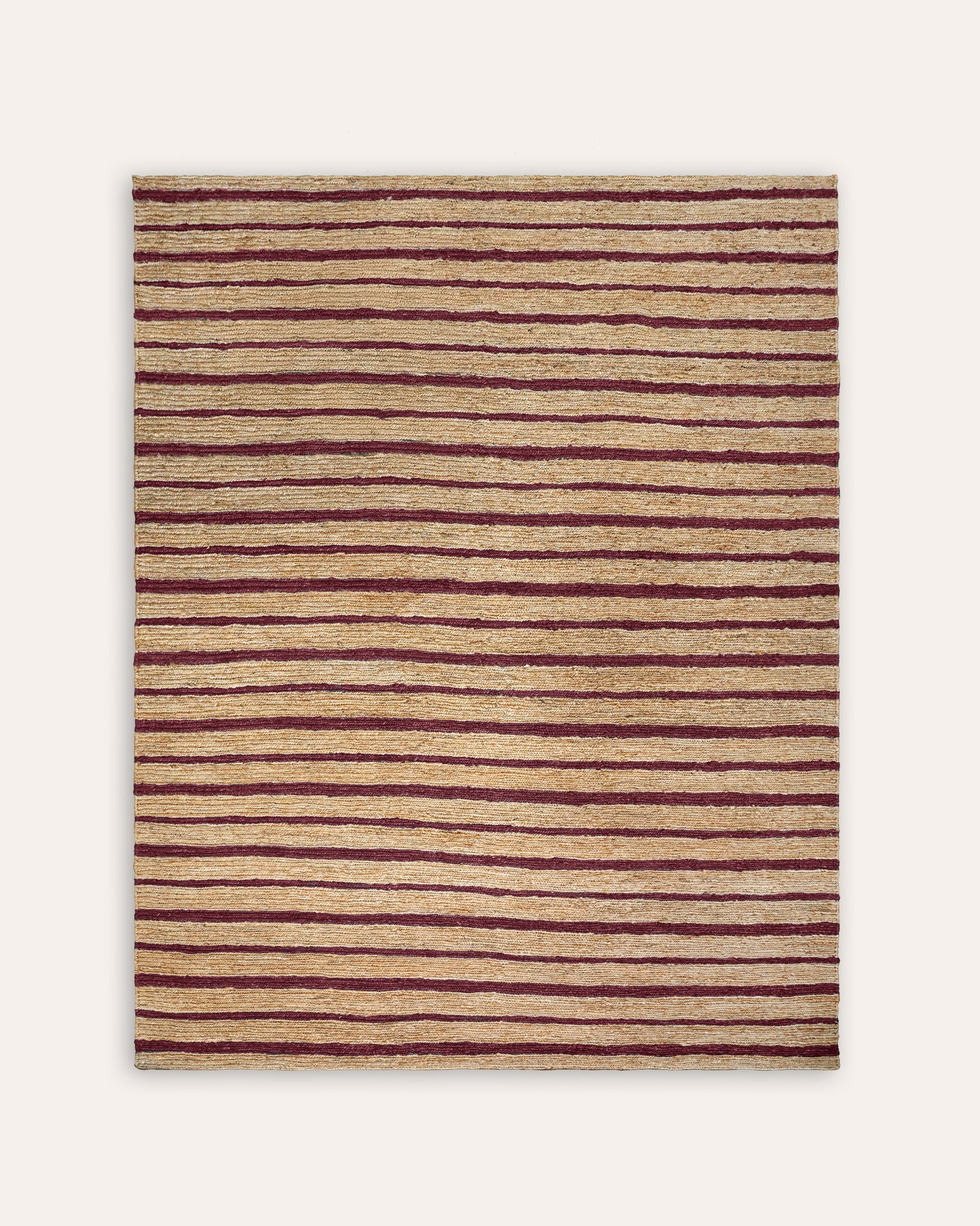 Striped rug with red and beige stripes on a white background