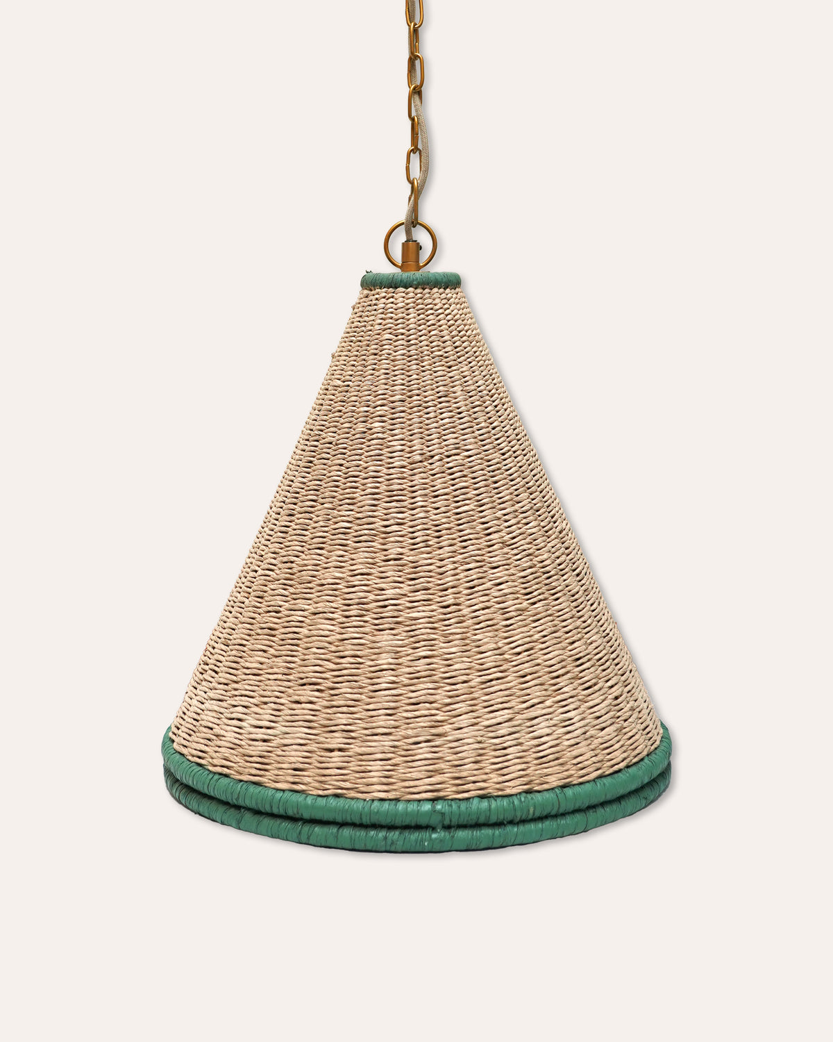 A natural woven seagrass pendant light shade with a dark green braided trim at the top and bottom, suspended by a gold-toned chain against a light beige background.