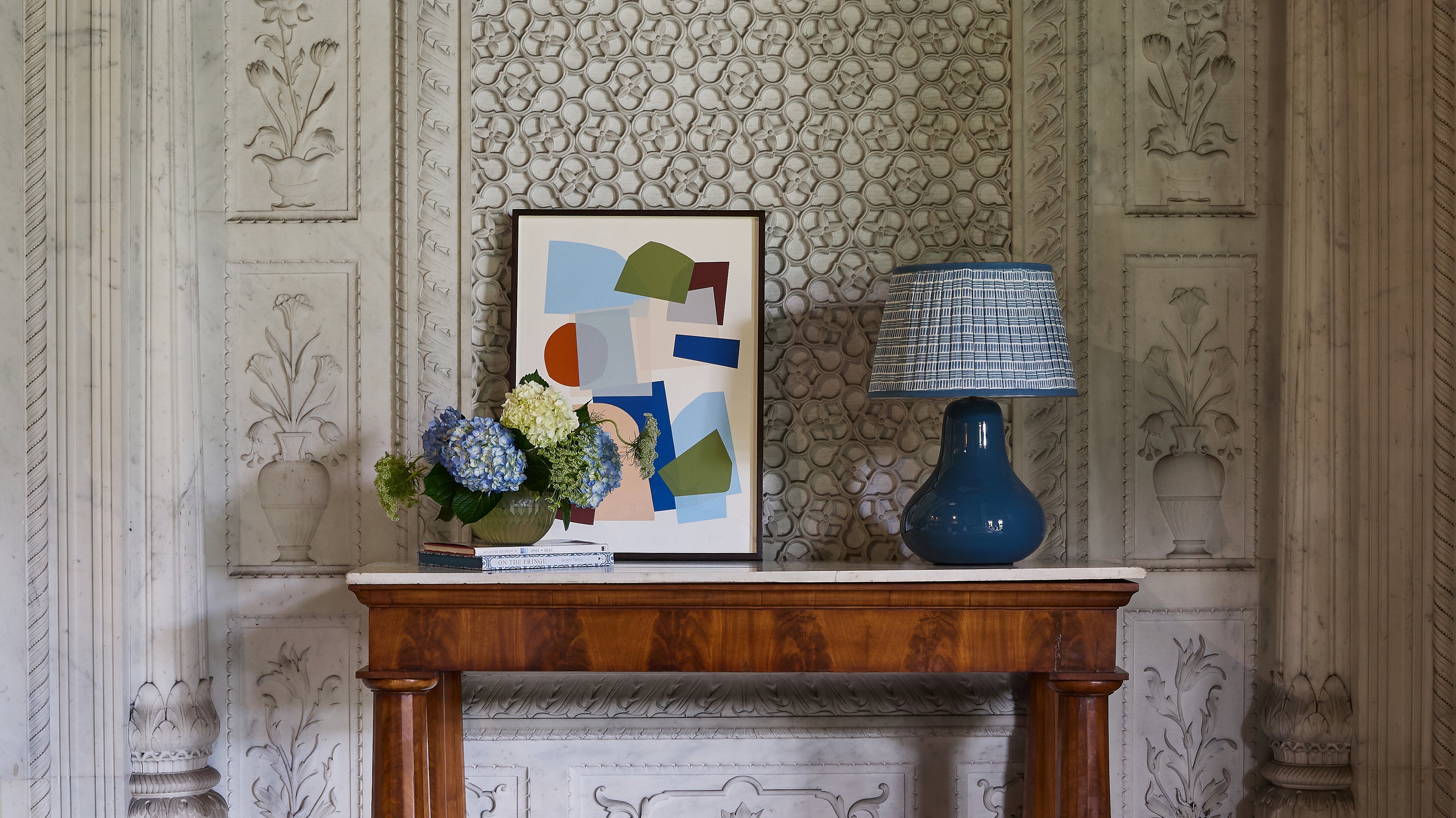 The gallery, artwork featured on wall behind a green and taupe dining set up