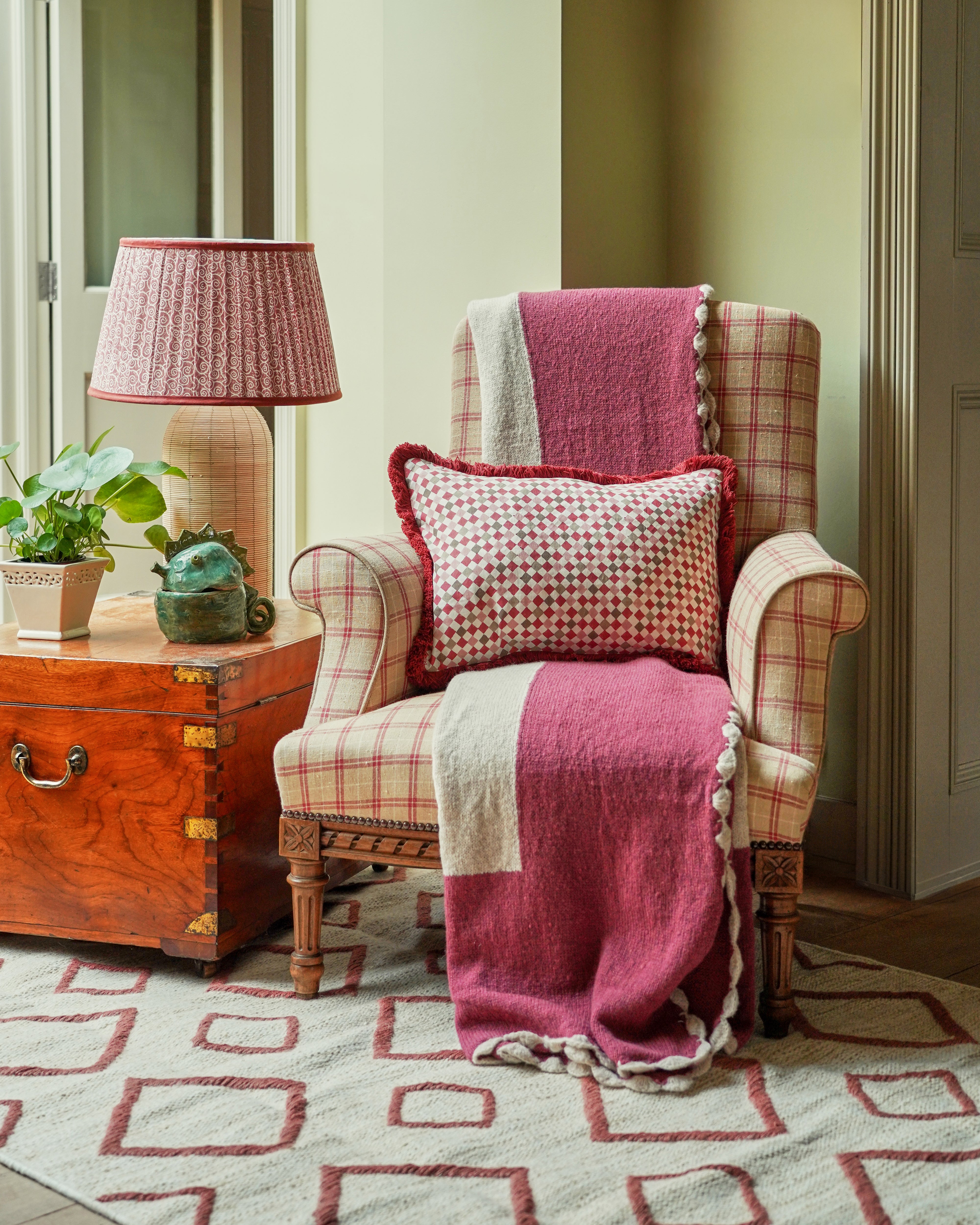 pink throw and cushion on chair