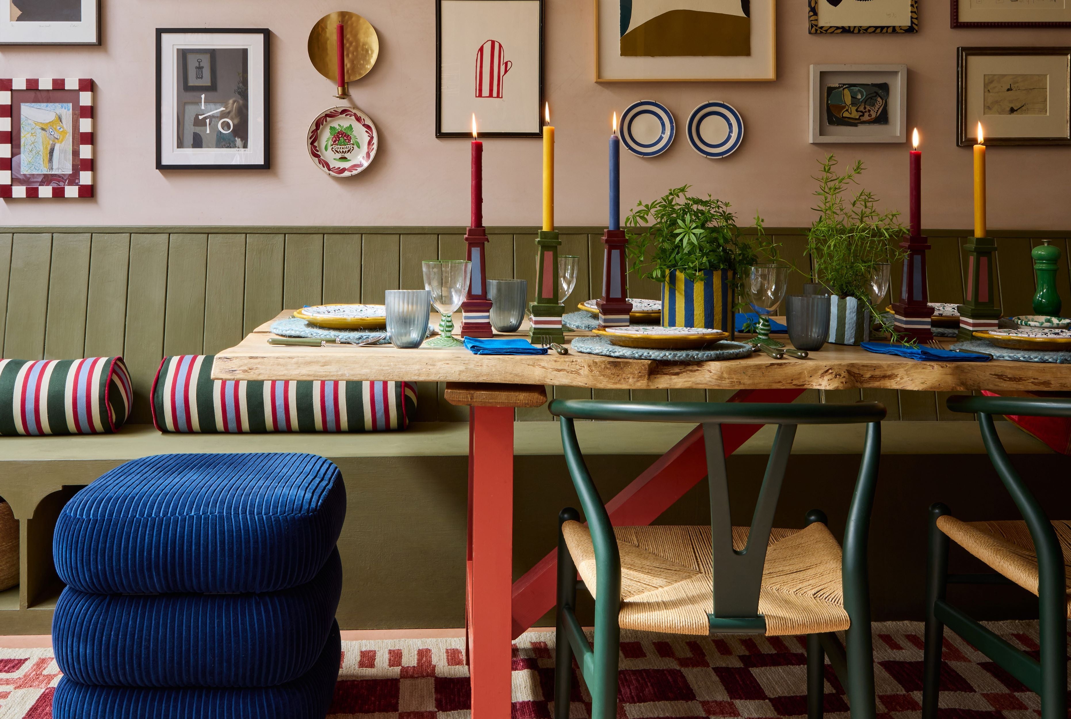 dining shot of a colourful dining table with candlesticks and a bright blue stool