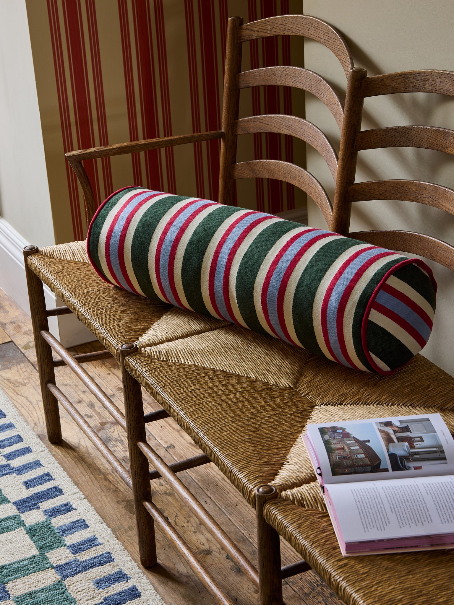 The Stripes Galore Bolster cushion on a bench