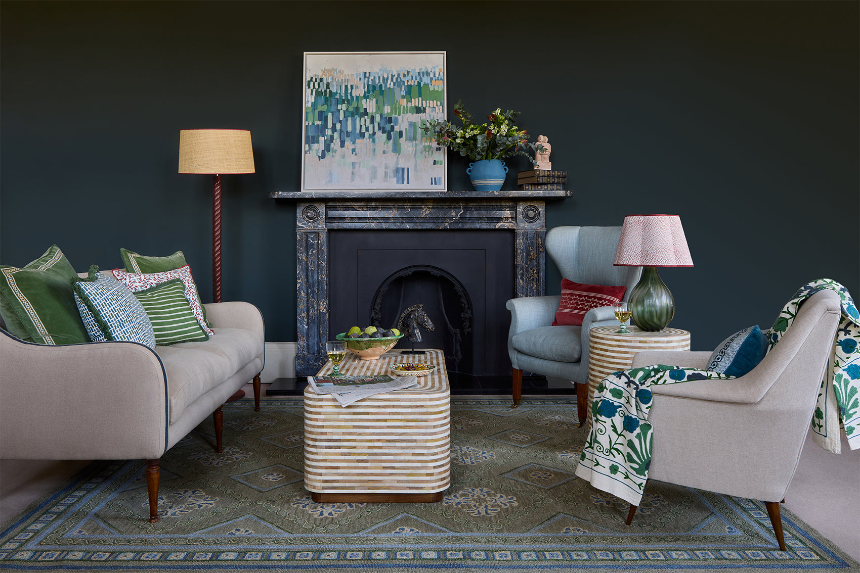 Red, blue and green sitting room with sofa, armchair, side table and coffee table.